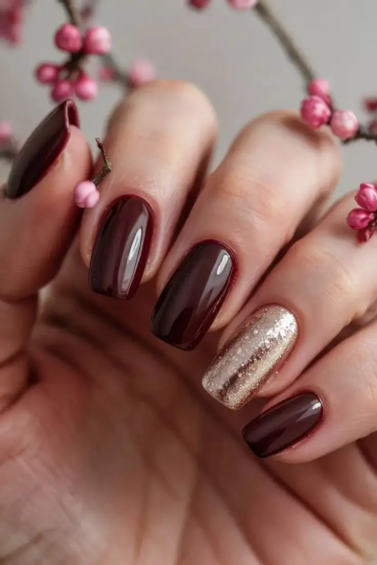 winter-nails-trends-deep-cherry-wine-with-holiday-gold-sparkle