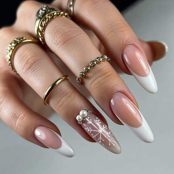 French nail designs 2026 Almond French with snowflake accent art
