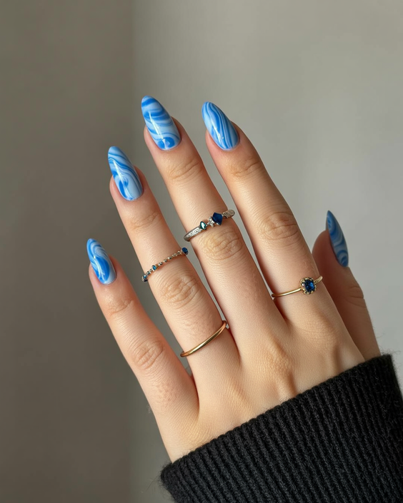 simple nails trend 2026 Blue Marble Almond Nails