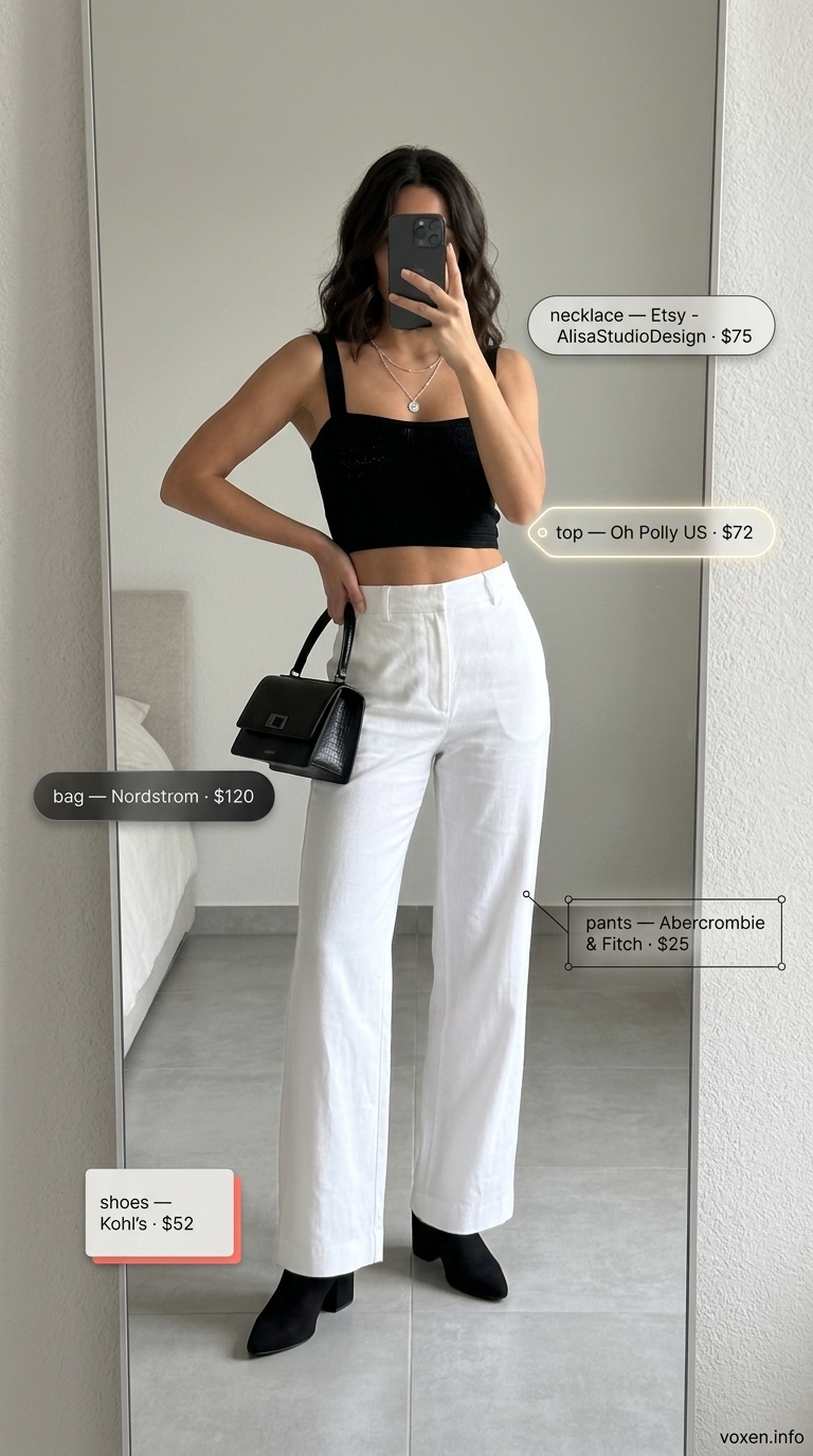 Black crochet crop top with wide-leg trousers for summer crochet outfits for women 2026. Sophisticated city style.