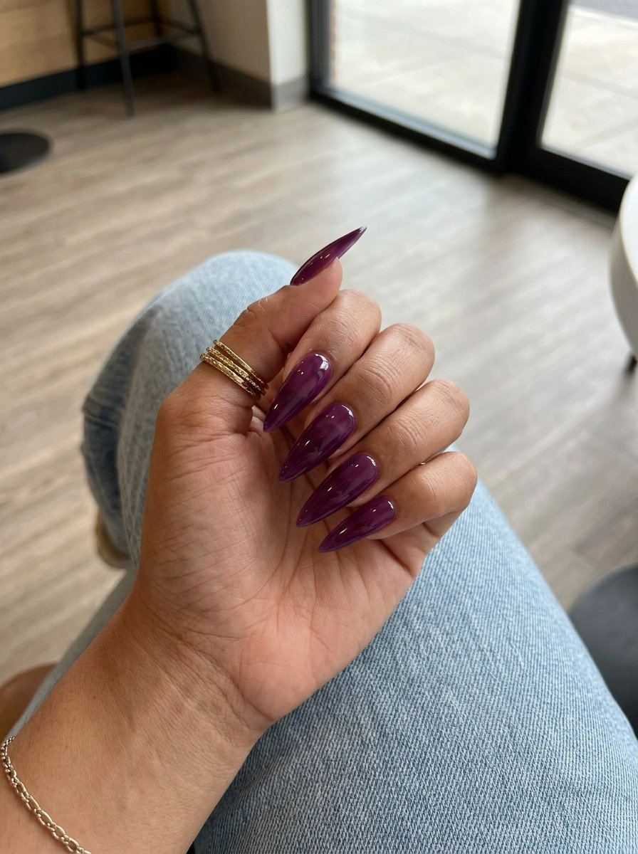 Grape Jelly Stiletto nails for summer fruits nail art 2026. Sultry, bold, and edgy deep grape purple translucent jelly finish.