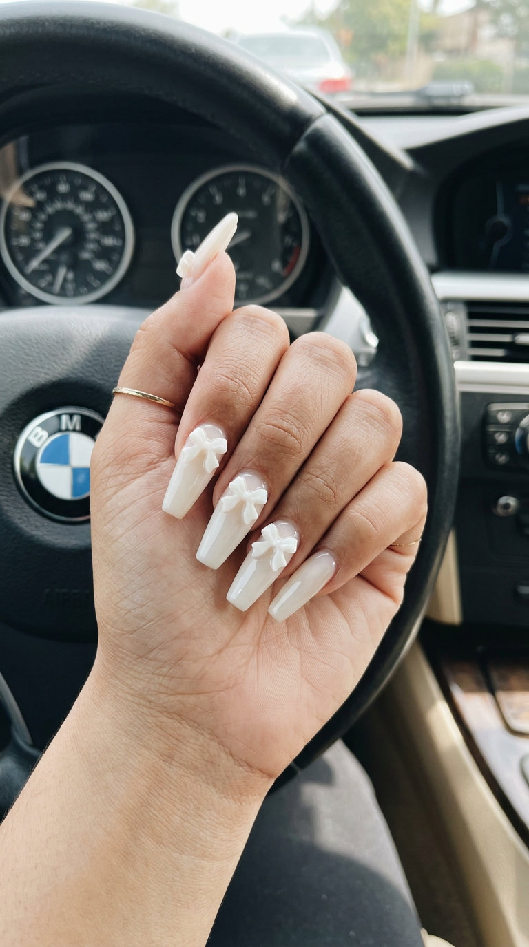 Milky White 3D Bow Coffin Nails 2026 Long summer nails 2026: Romantic milky white coffin nails with 3D bows for a wedding guest.