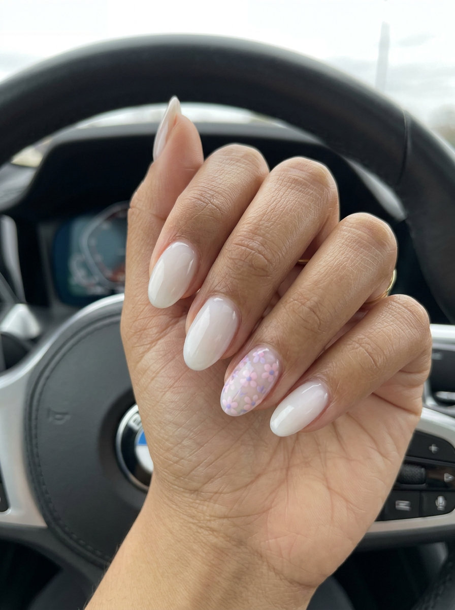 Milky White Oval Summer Nails 2026 Milky white oval summer nails 2026 with floral accents for all skin tones. Ethereal bridal shower style.
