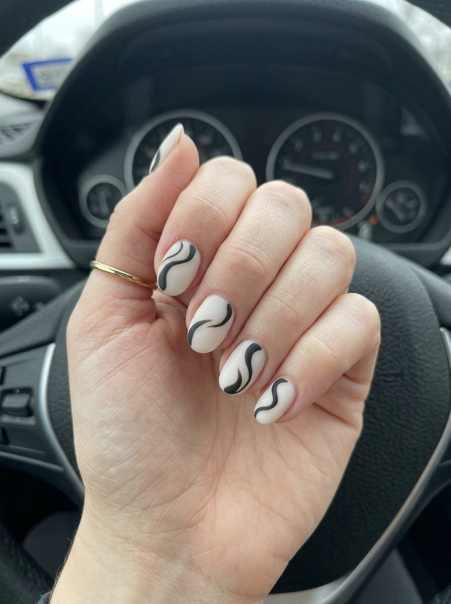 Monochrome Abstract Swirls Nails 2026 Short oval summer nails 2026: Milky white with matte black abstract swirls. Minimalist for work.