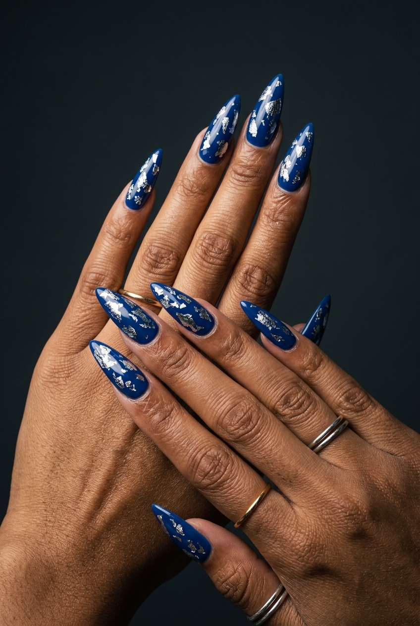 Deep jewel-toned stiletto nails with scattered silver chrome flakes for bold spring chrome nails 2026.