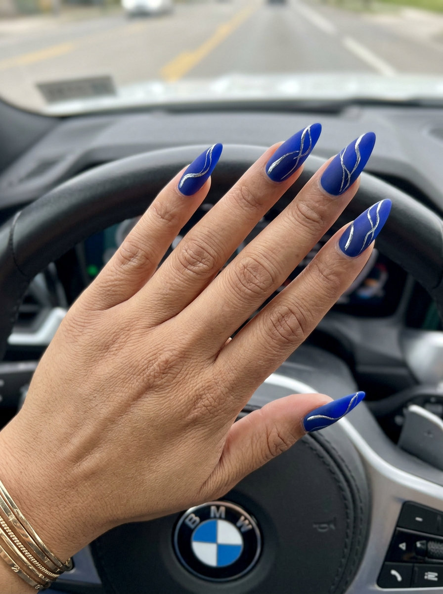 Cobalt blue matte nails with silver chrome abstract lines are edgy summer colorful nails designs 2026.