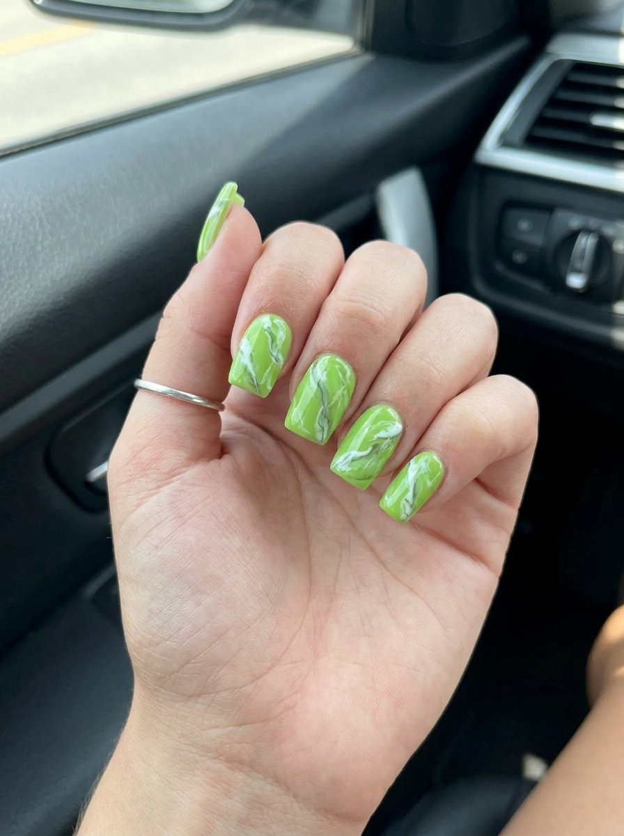 Abstract lime marble nails for summer colorful nails designs 2026. Artistic lime green, white, and grey marbling.