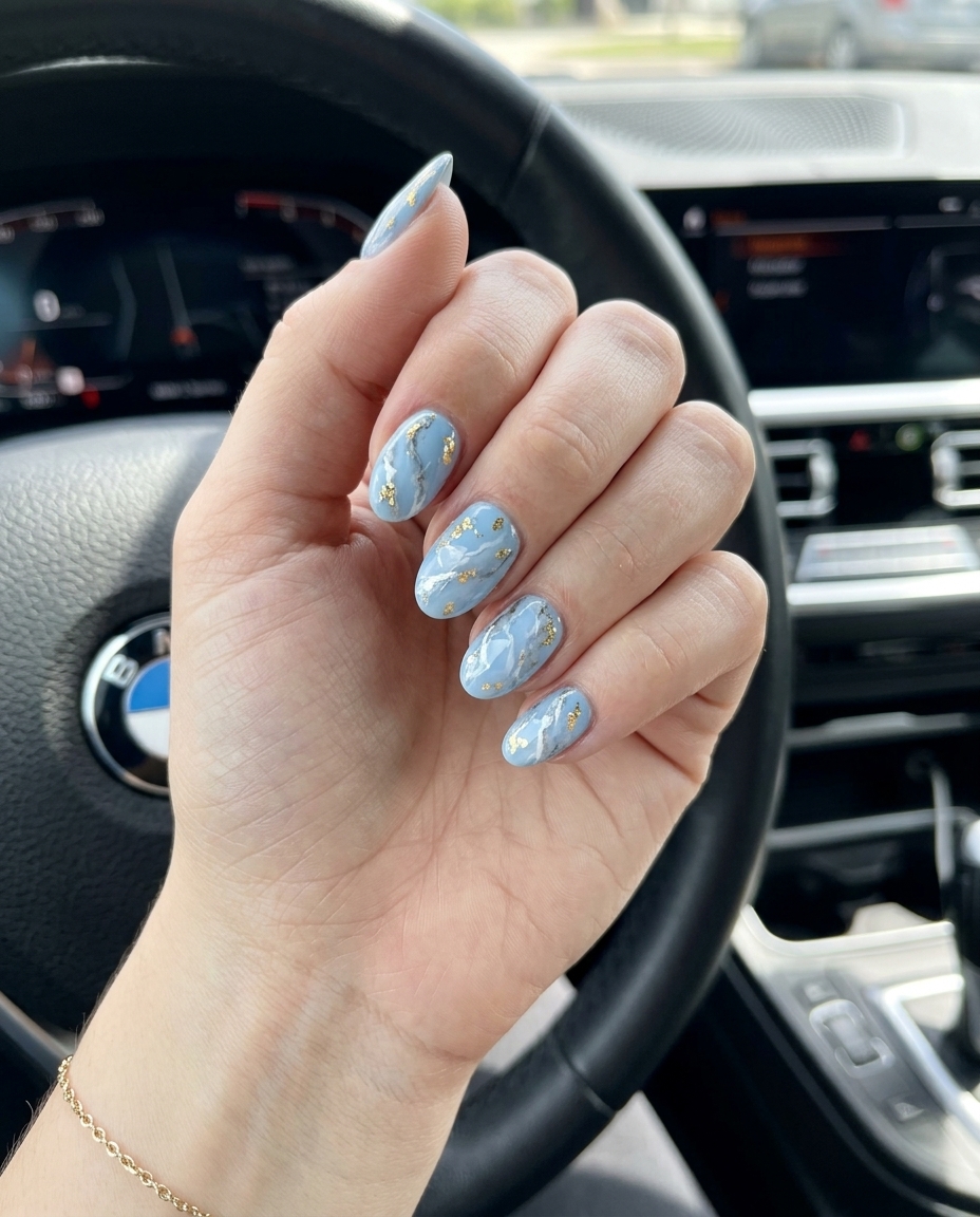 Summer colourful nails 2026: Sky blue marble with gold flakes for elegant formal events and date nights.