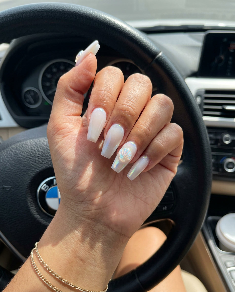 Shell Accents Milk Bath Coffin Nails 2026 Shell accents milk bath coffin nails for summer holiday nails 2026. Whimsical beach trip, wedding guest style.