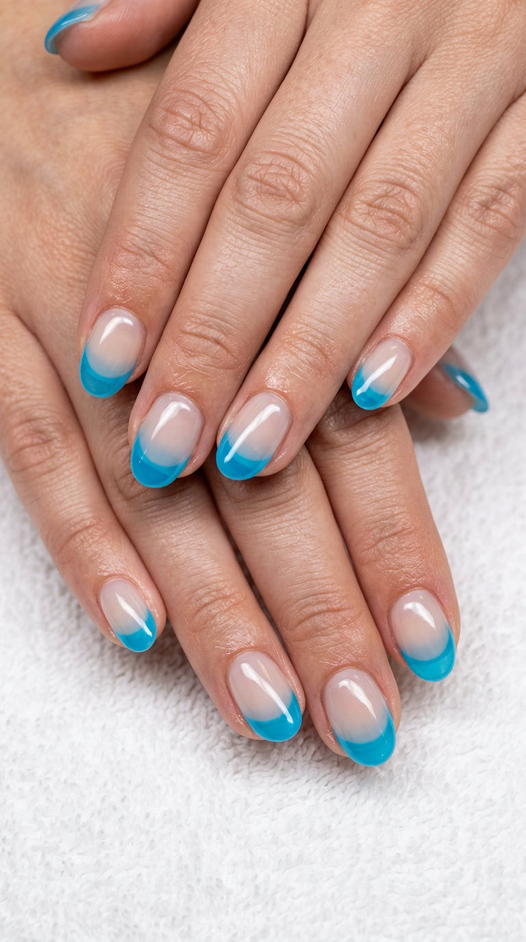Icy Blue Jelly French nails for pale skin 2026: sheer nude base with translucent icy blue tips. Great for vacation, festivals.