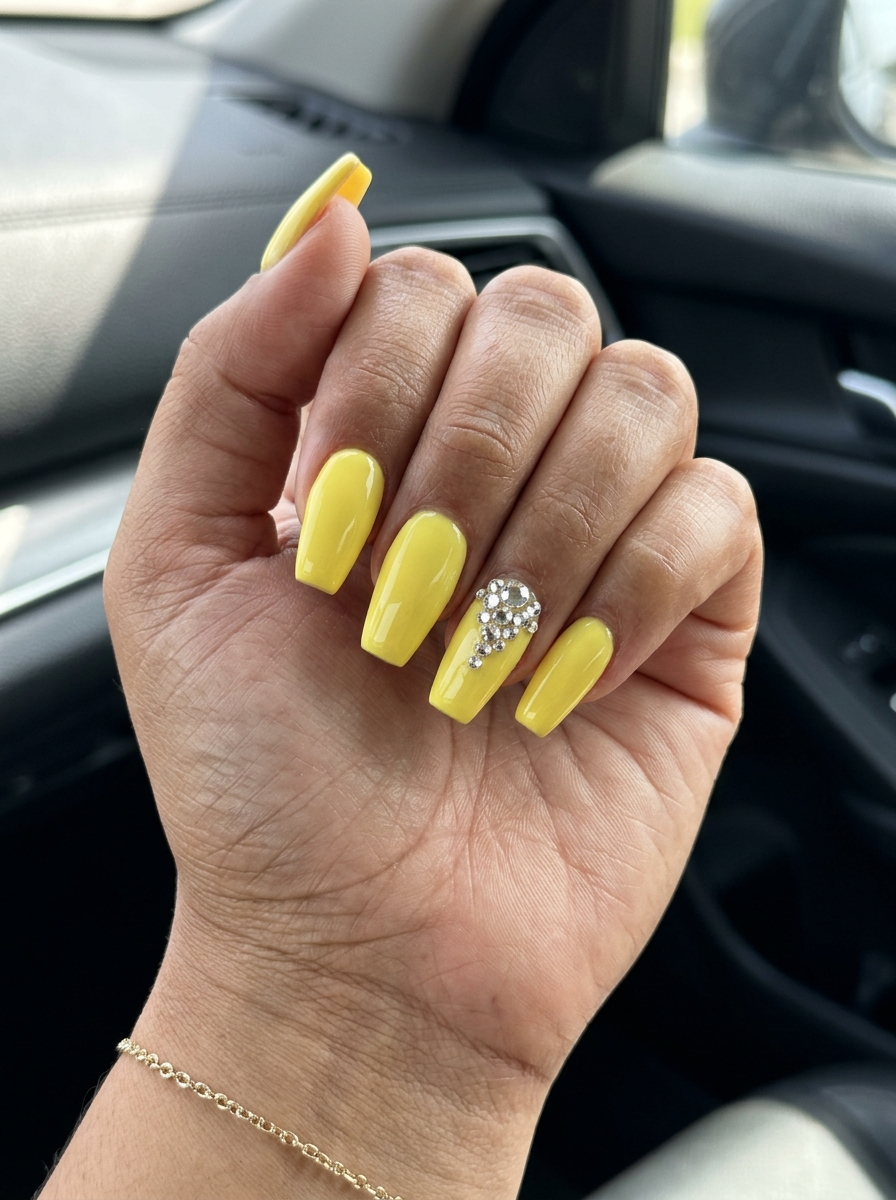 Lemon Zest Rhinestone Nails 2026 Glamorous lemon zest yellow coffin nails with crystal rhinestones for summer nails yellow 2026 party looks.