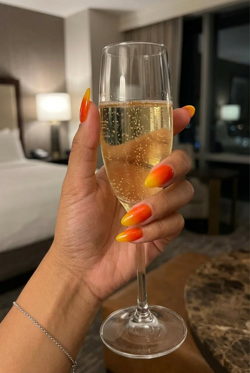 Vibrant Summer Ombre Nails 2026: Jelly Sunset Coffin Vibrant vacation summer ombre nails 2026 in jelly sunset orange to yellow coffin.