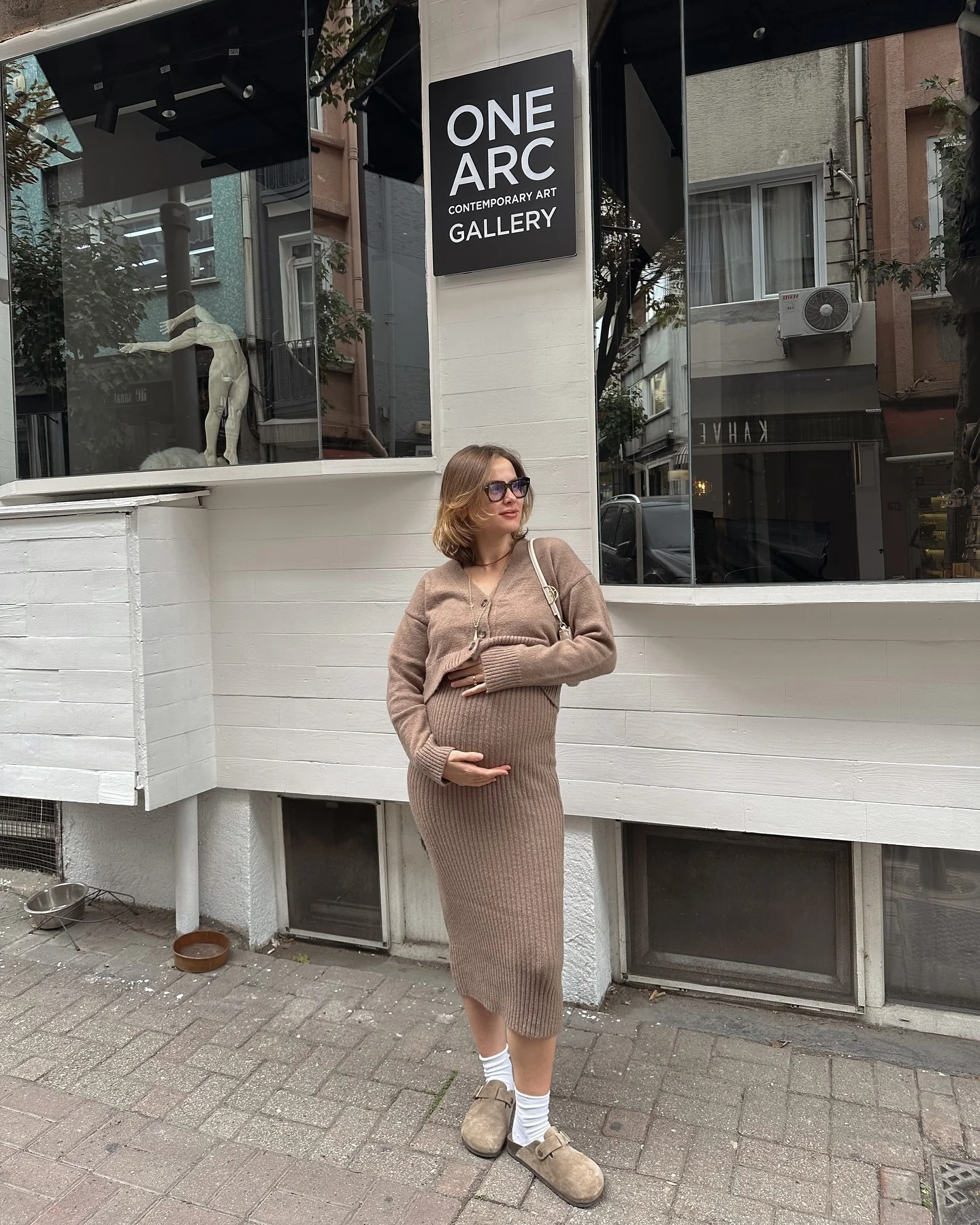 fall pregnancy outfits 2026 Minimal Knit Dress Styled With Soft Neutral Accessories
