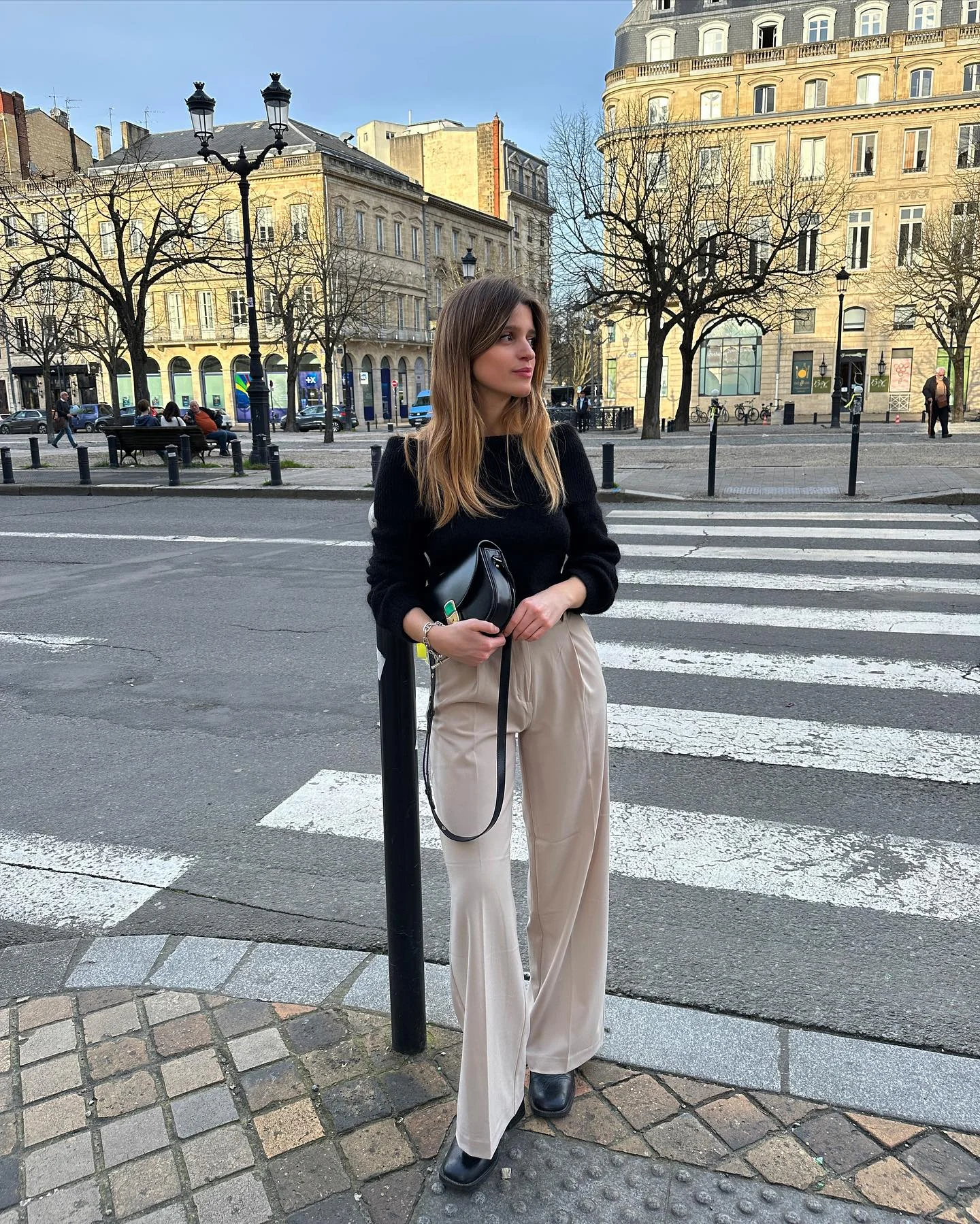 fall outfits wide leg trousers 2026 Soft Beige Trousers Styled With Classic Black Knitwear