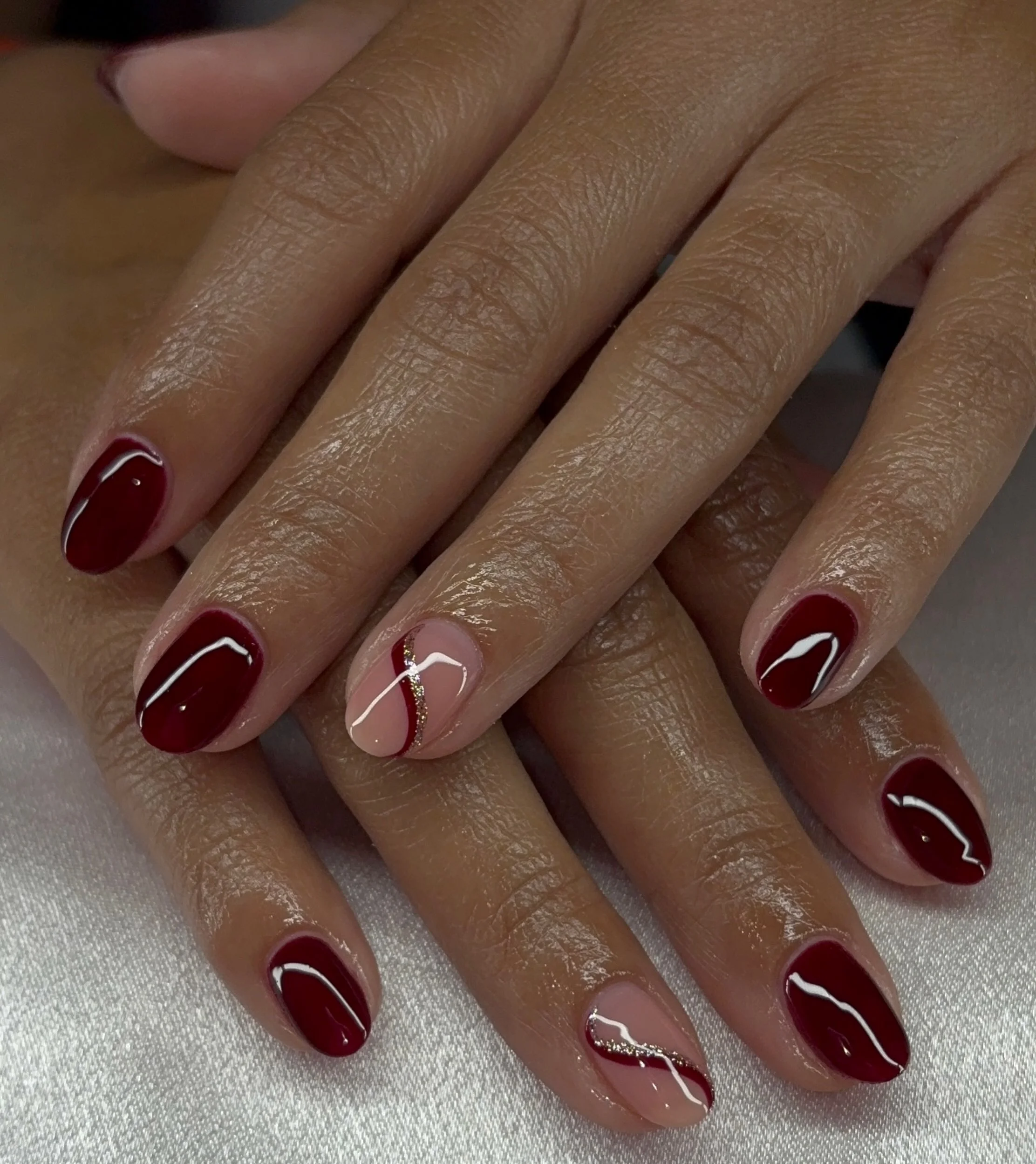 fall red nails 2026 Minimal Burgundy Waves With Delicate Gold Accents