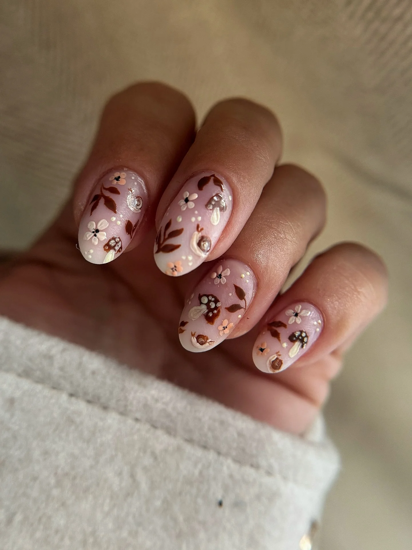 september nail art ideas 2026 Soft Blush Woodland Floral Nails With Tiny Mushrooms
