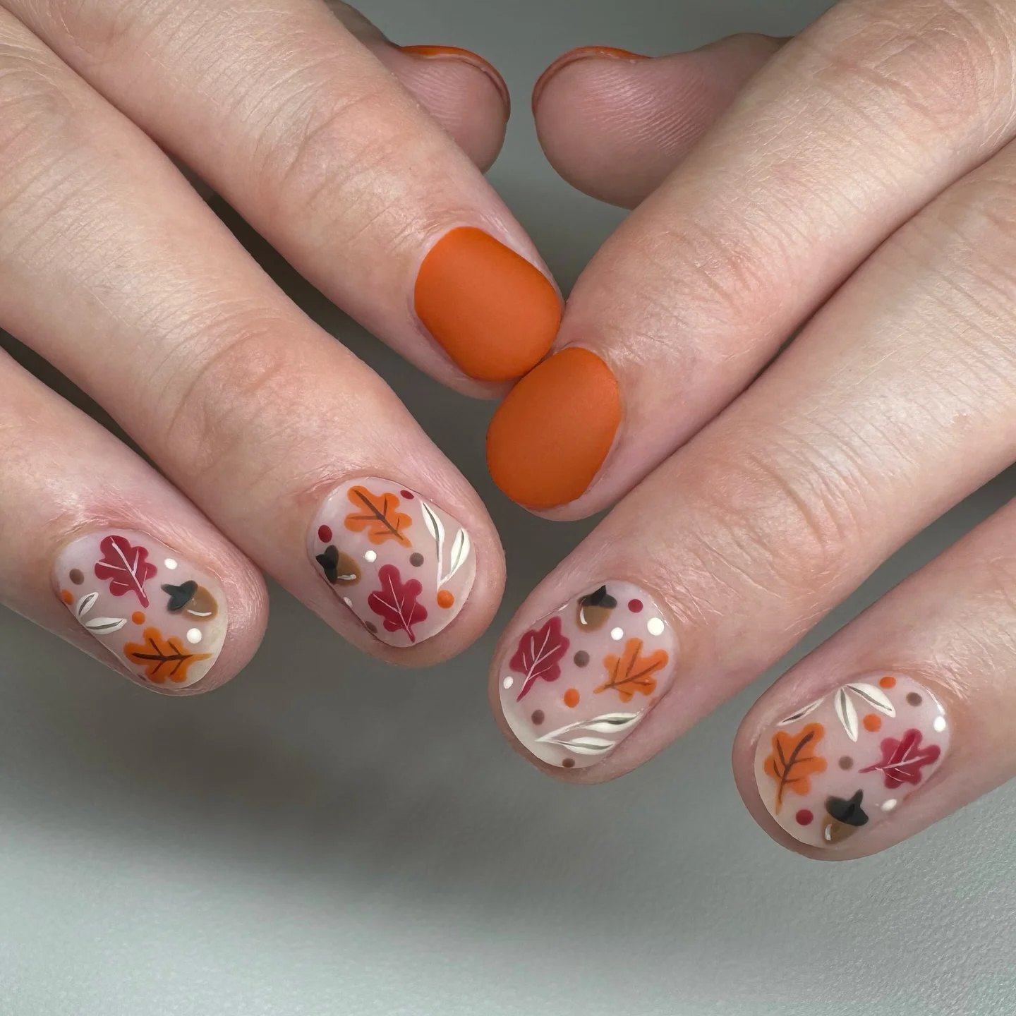 september nail art ideas 2026 Minimal Autumn Leaves On Matte Orange Short Nails