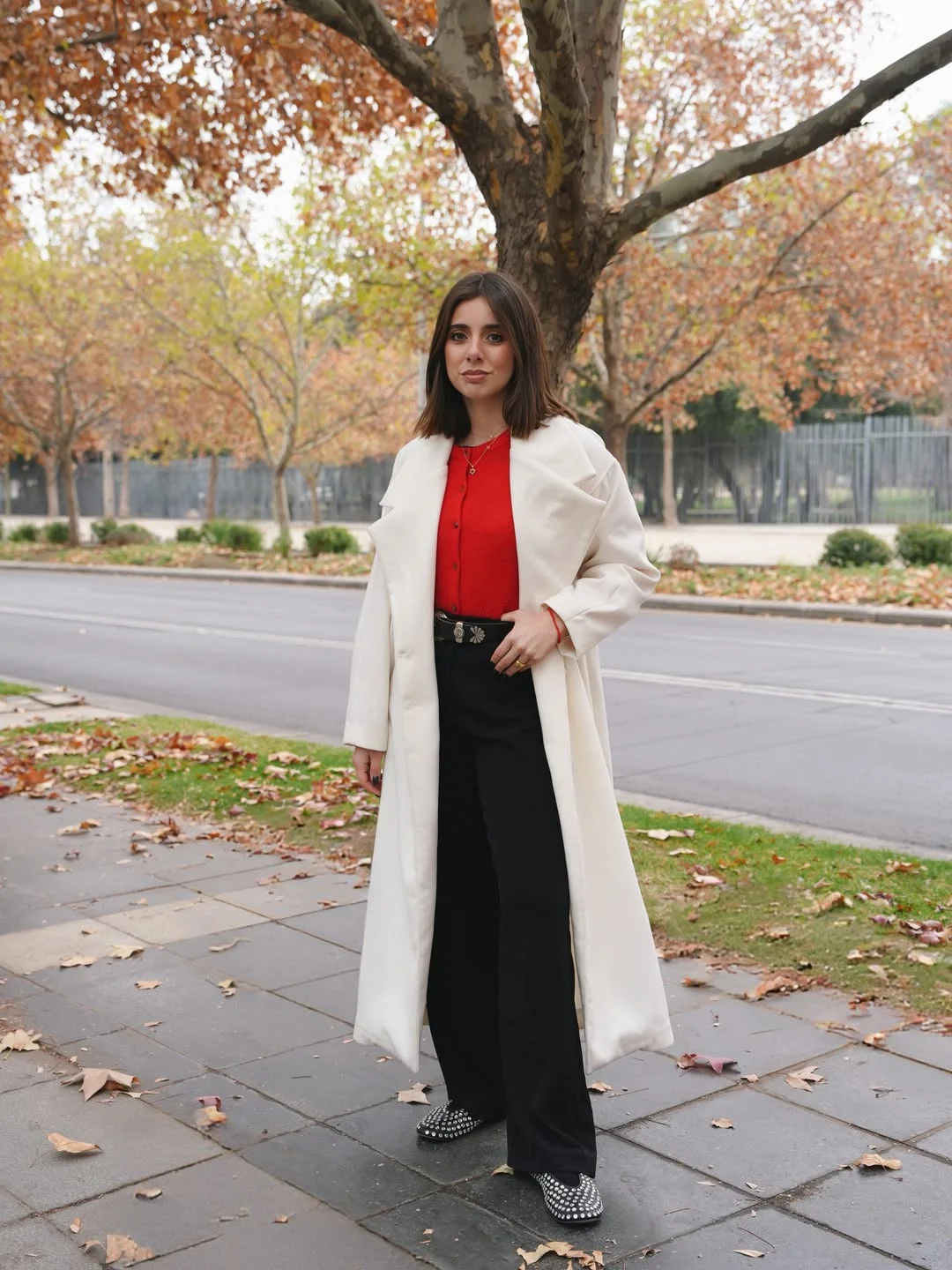 trench coat fall outfits 2026 Bright Red Knit Under A Long Ivory Trench