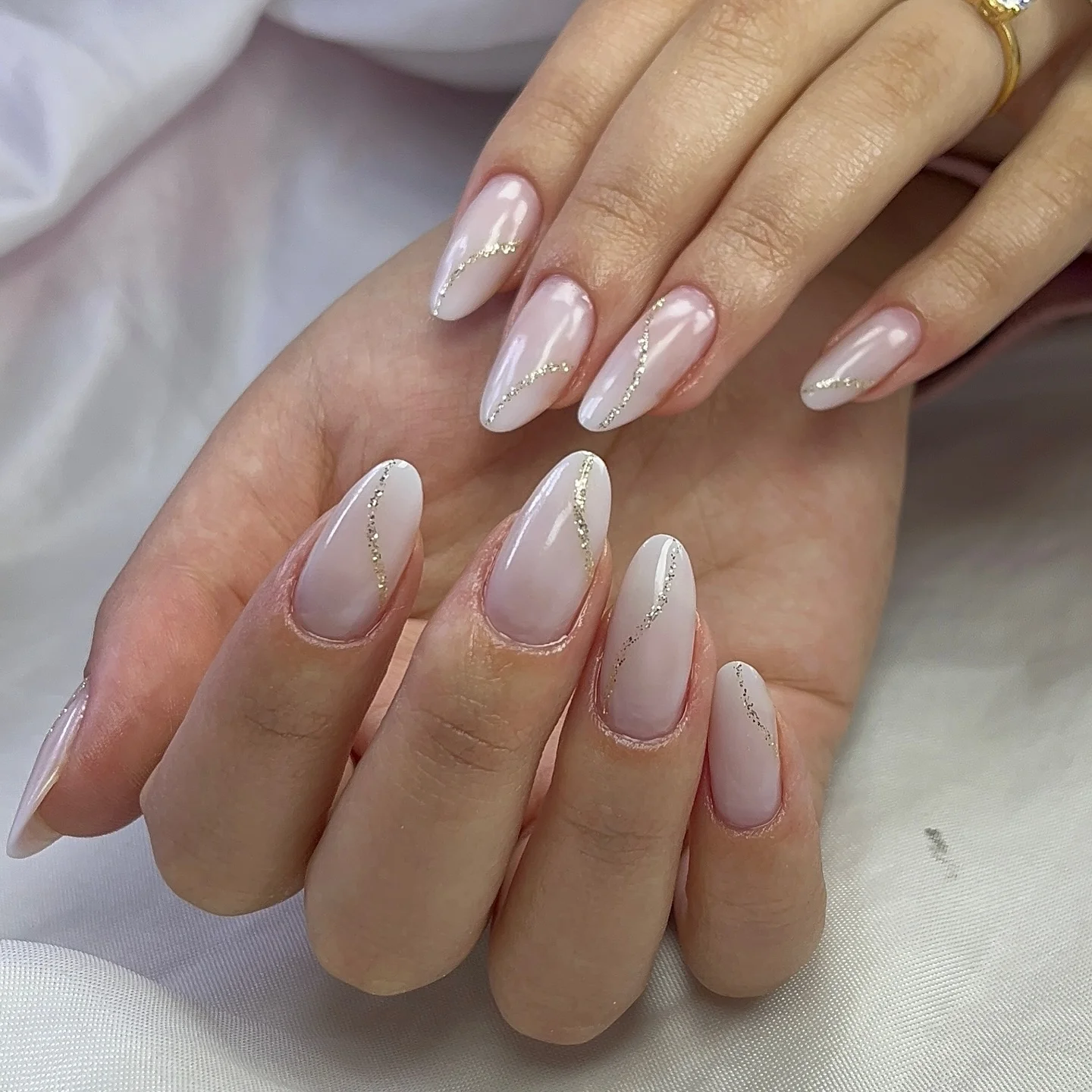 fall almond nails 2026 Soft Pearl Almond Nails With Delicate Gold Waves