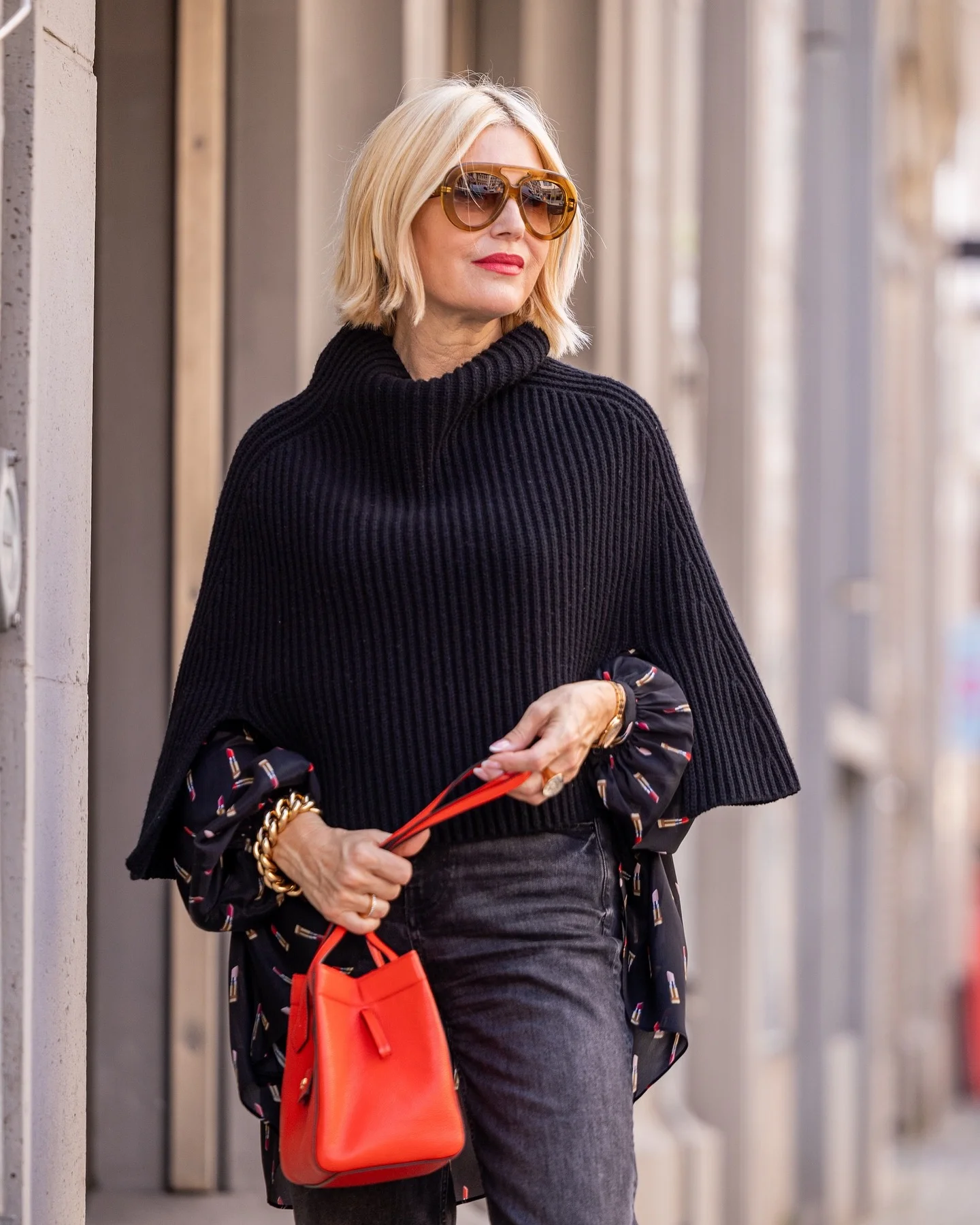 fall poncho outfits 2026 Chunky Black Knit Poncho With Statement Accessories