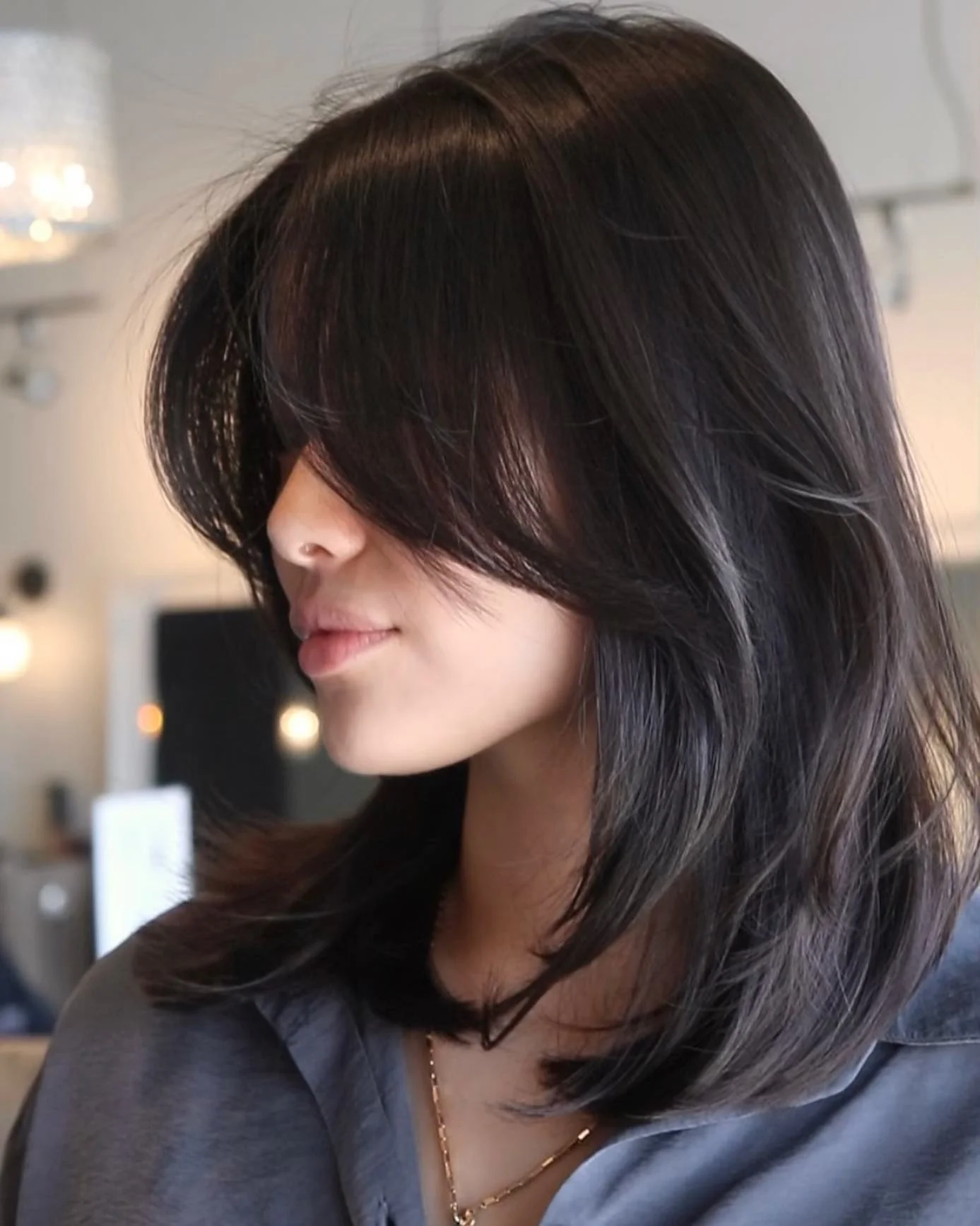 choppy medium layered hair Glossy Midnight Layers With Dramatic Face-Framing Bangs
