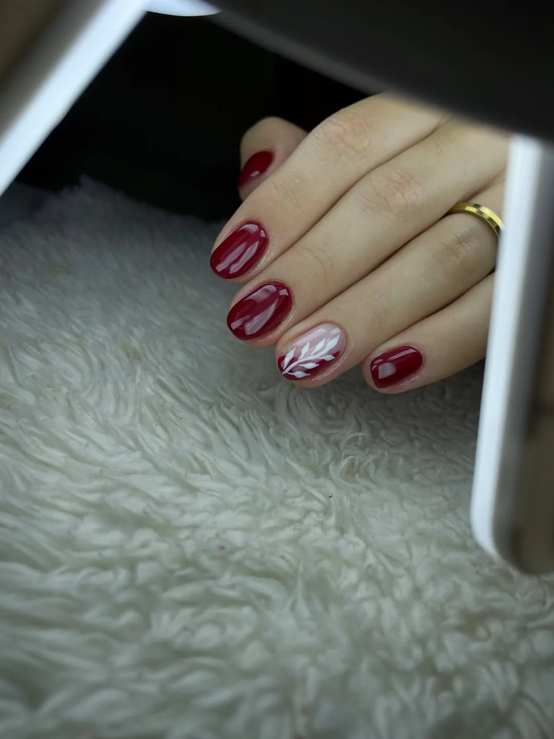 fall red nails 2026 Classic Burgundy Nails With Delicate White Leaf Accent