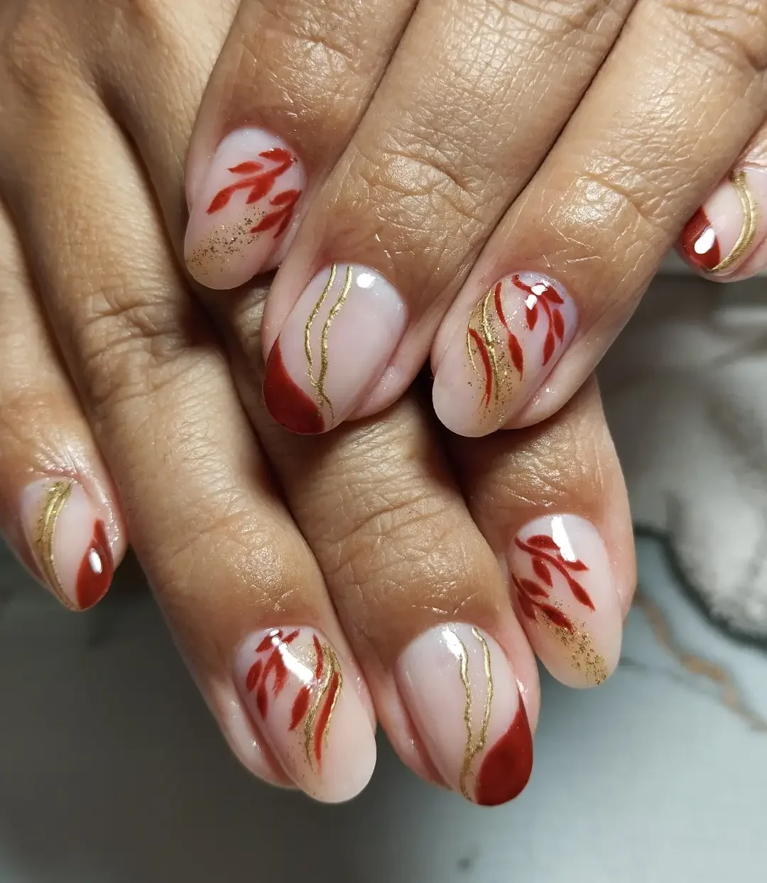 fall red nails 2026 Modern Nude And Terracotta Leaf Nail Art