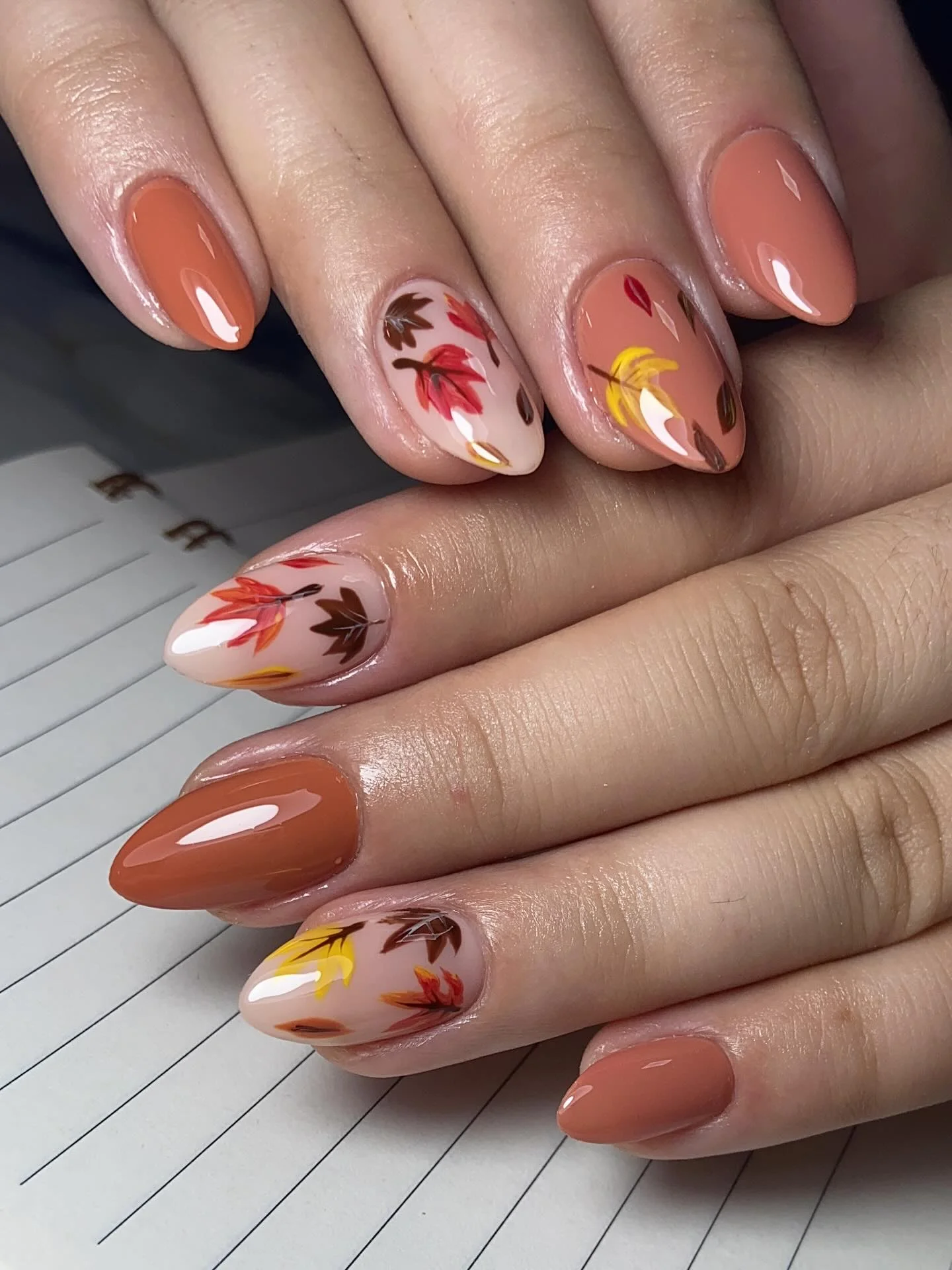 september nail art ideas 2026 Warm Cinnamon Almond Nails With Falling Autumn Leaves