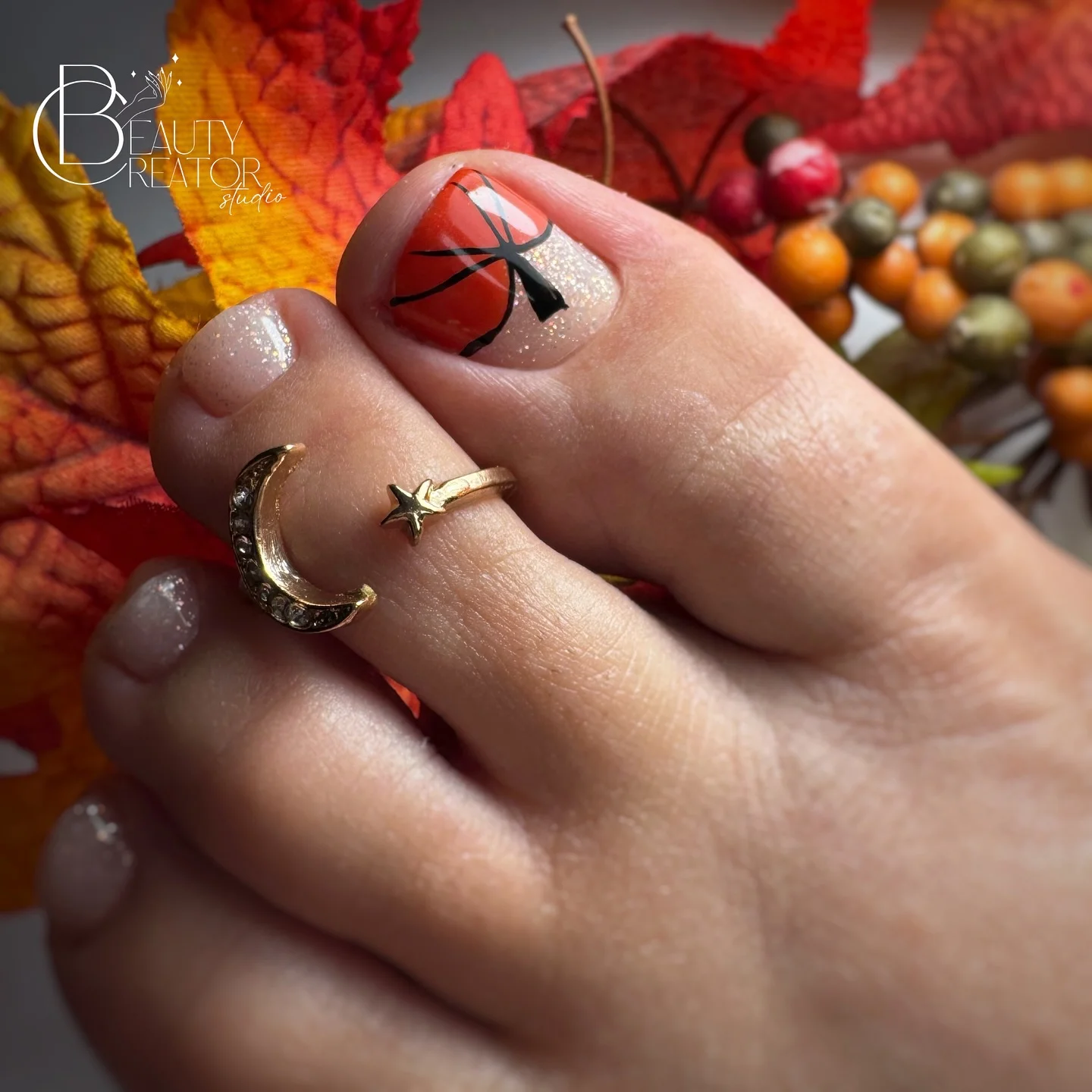 fall pedicure ideas 2026 Burnt Orange Sparkle With Graphic Ribbon Art