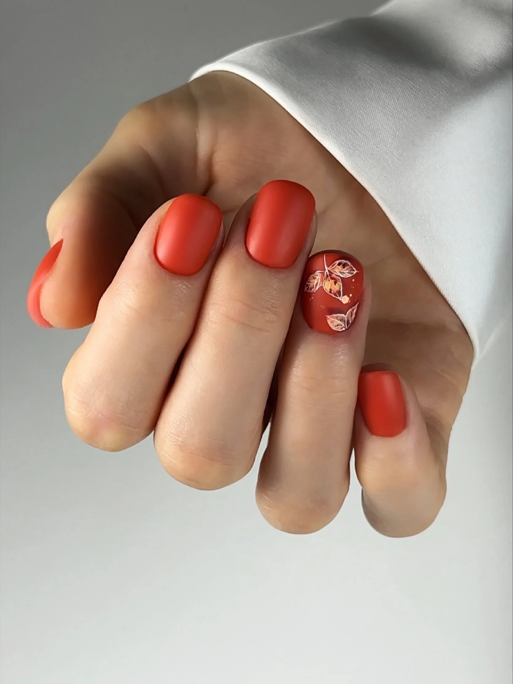 fall nails with accent nail Warm Red Nails With A Delicate Botanical Accent