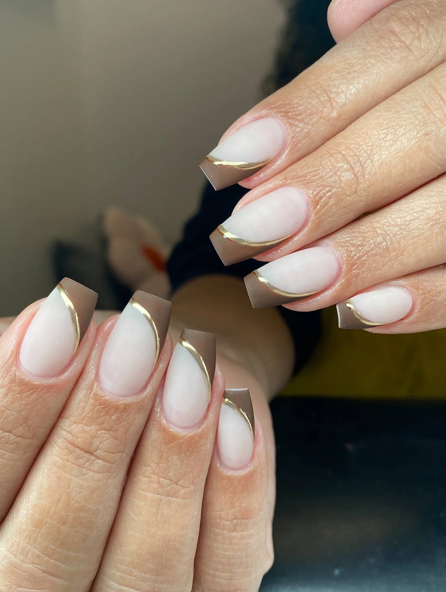 fall short coffin nails designs 2026 Soft Taupe Coffin Nails With A Delicate Gold French Tip