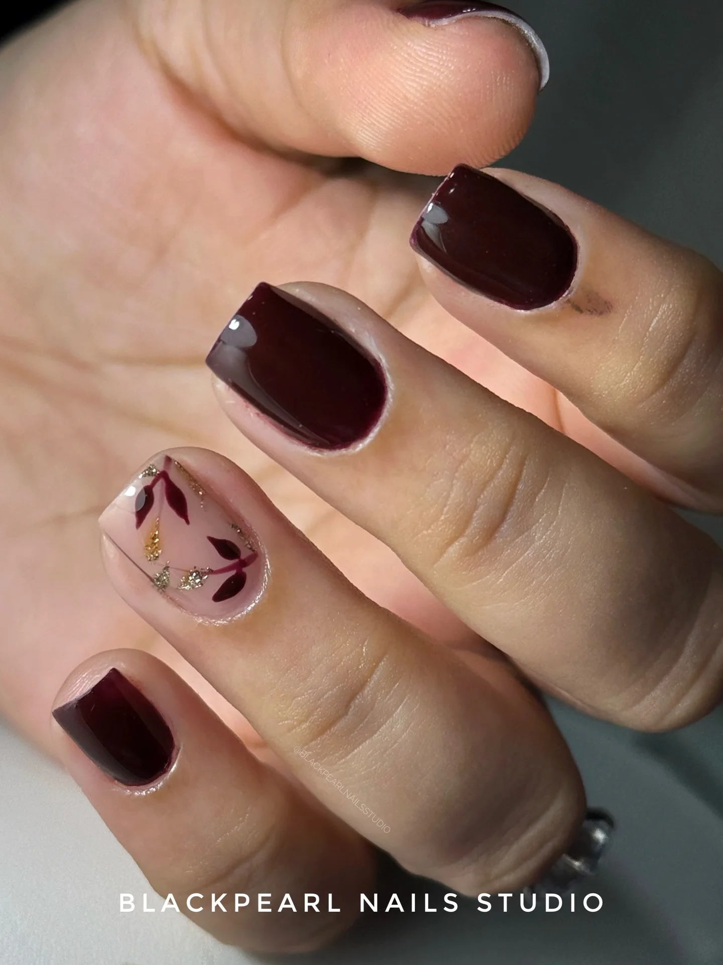 fall burgundy nails with design Deep Burgundy Short Nails With Delicate Gold Leaf Art