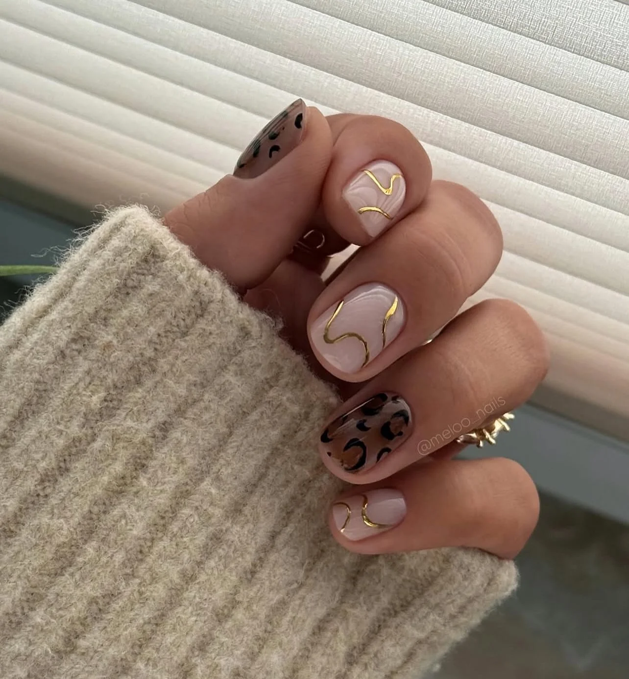 fall nails for olive skin tone 2026 Soft Nude With Gold Waves And Leopard Details
