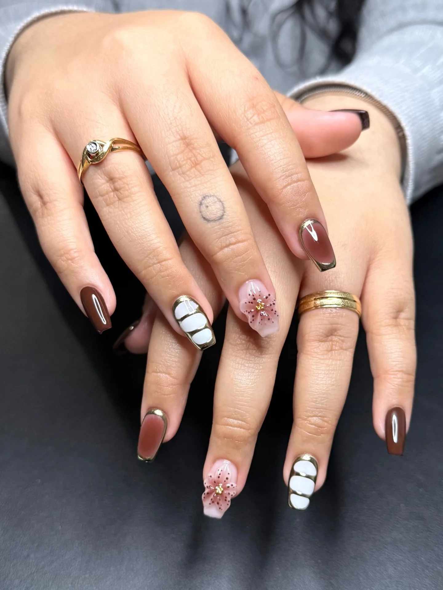 fall short coffin nails designs 2026 Chocolate Brown Coffin Nails With Gold Frames And Floral Details