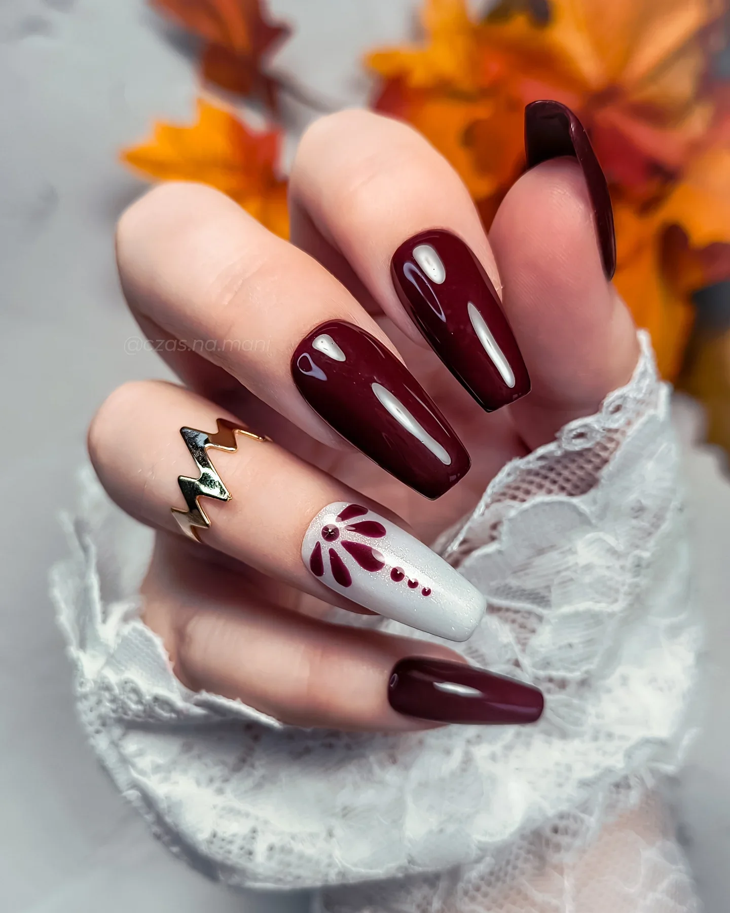 fall dark nail shadow ideas 2026 Oxblood Nails With Burgundy Floral And Gold Details