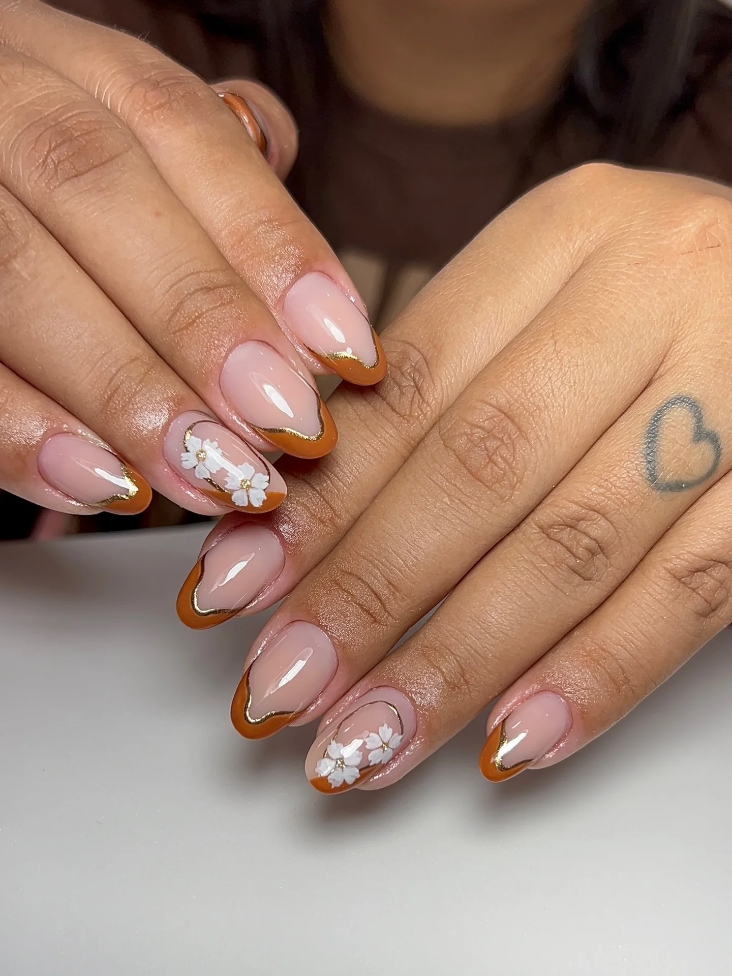 fall mid length nails 2026 Caramel French Tips With Elegant White Floral Details