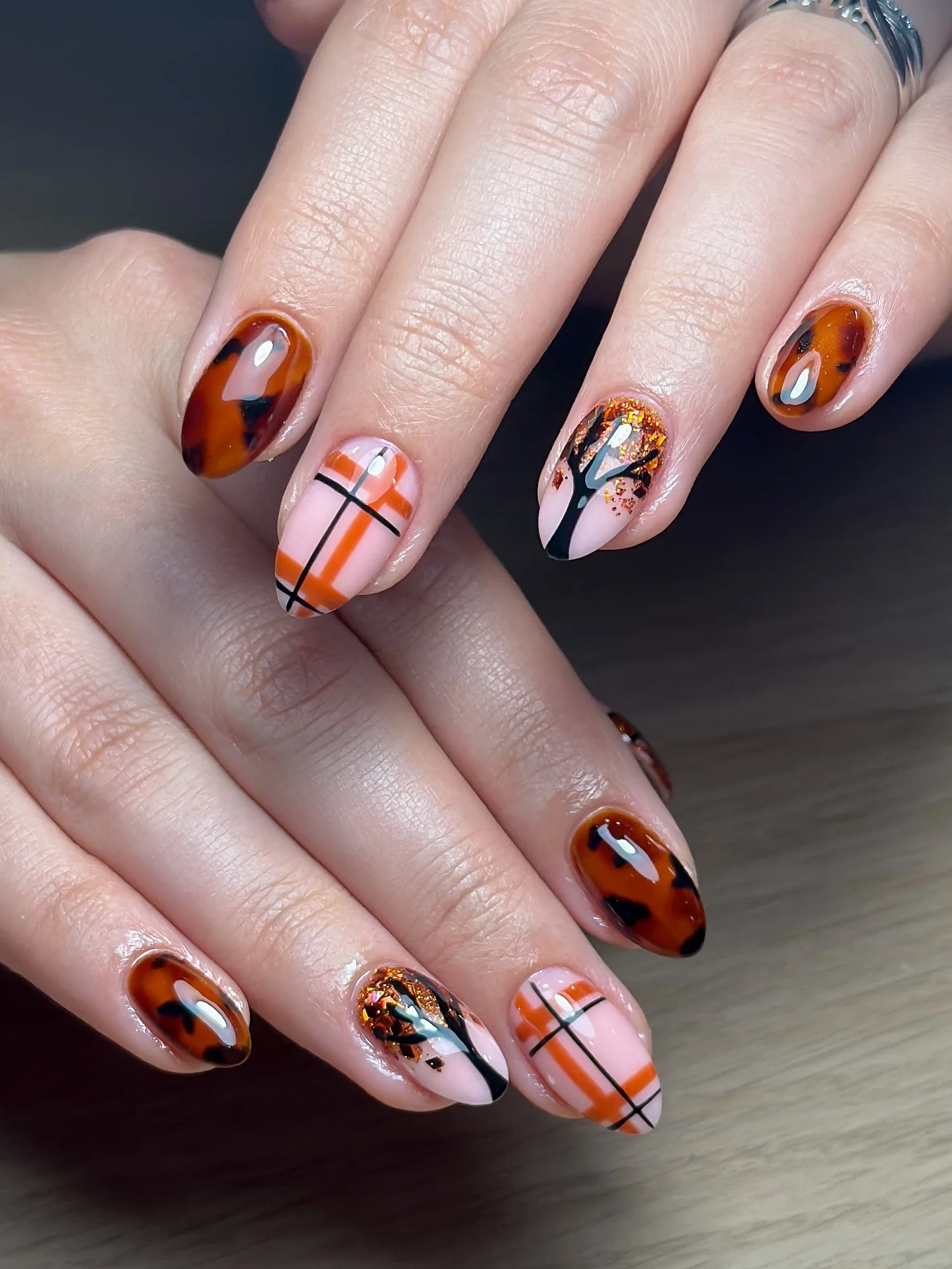fall nails for pale skin 2026 Tortoiseshell Plaid And Burnt Orange Mix