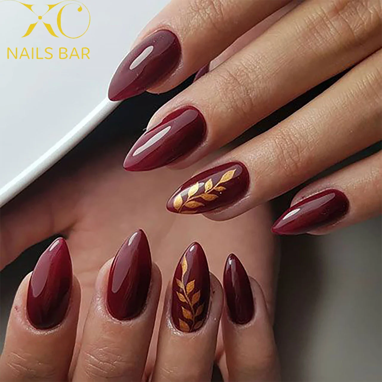 fall gel nails ideas 2026 Glossy Bordeaux Nails With Golden Leaf Art