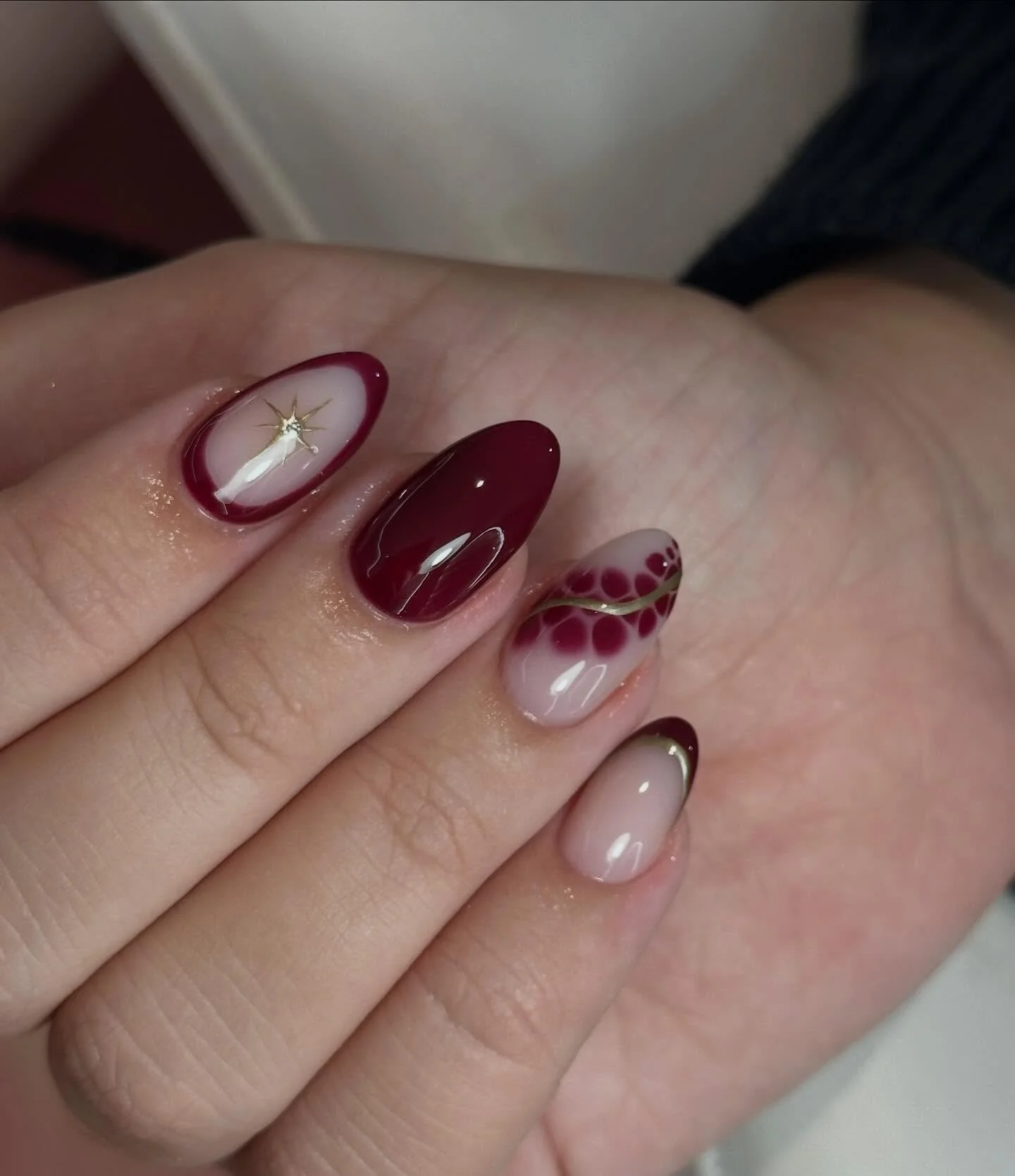 fall medium length nails 2026 Burgundy Almond Nails With Metallic Botanical Details