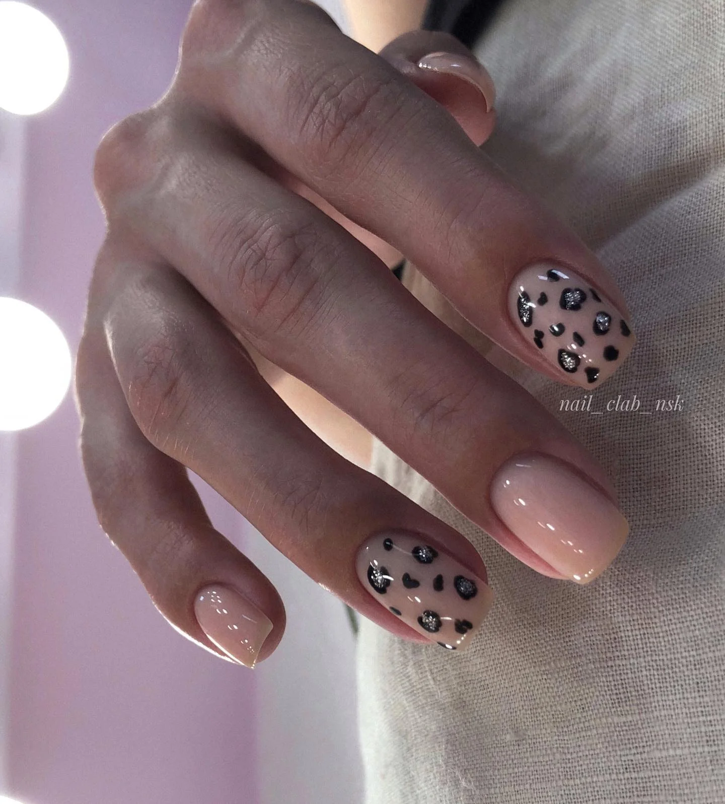 nude fall nails 2026 Glossy Nude Nails With Playful Black And Silver Spots