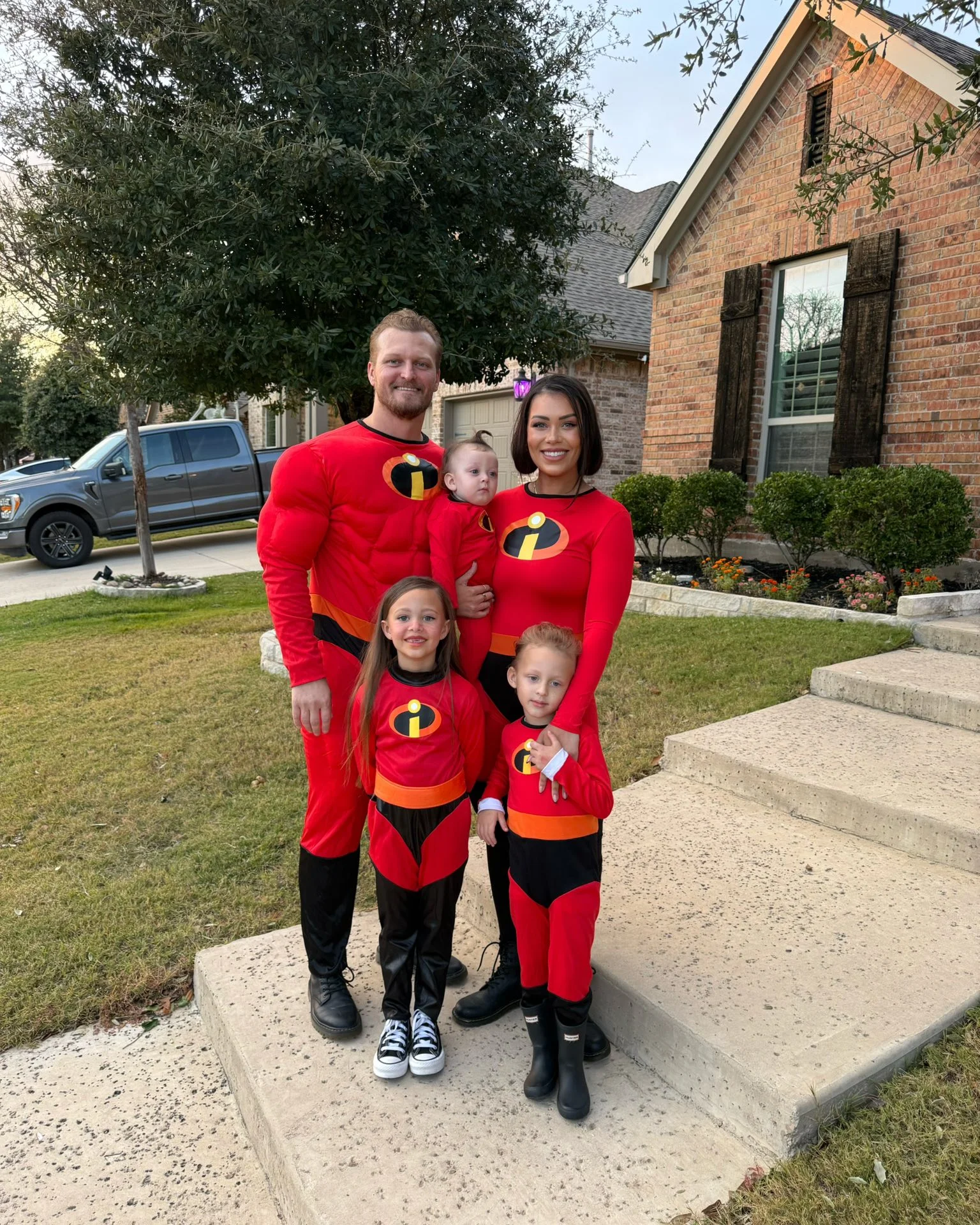 best halloween costume ideas 2026 Superhero Family In Red And Black