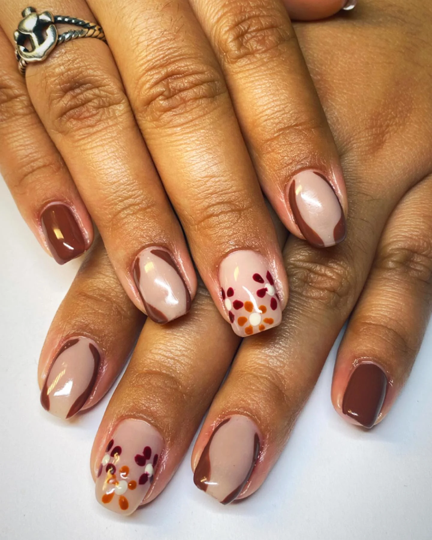 fall gel nails ideas 2026 Soft Nude Floral Nails With Chocolate Waves