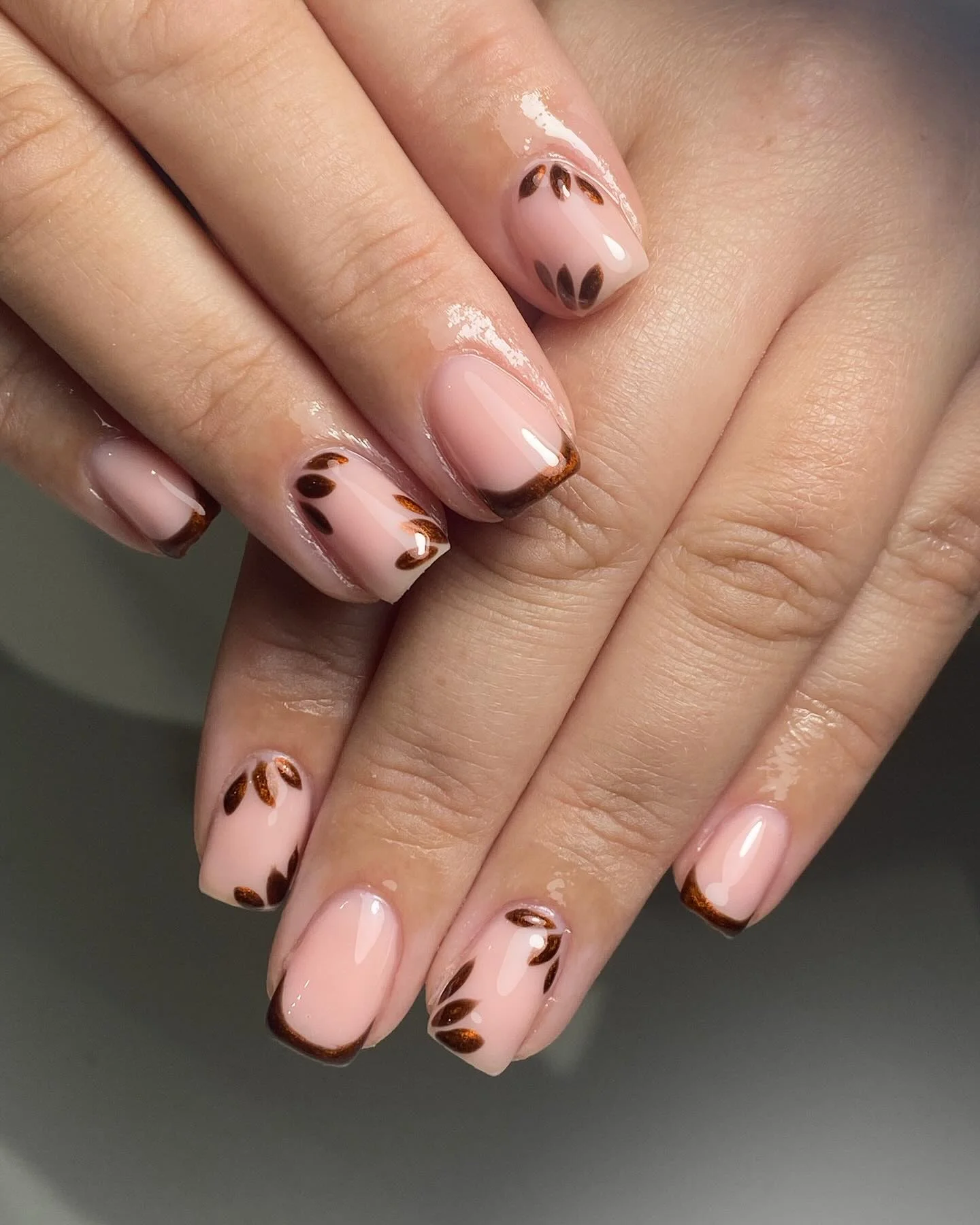 fall manicure ideas 2026 Soft Pink French Tips With Chocolate Leaf Details