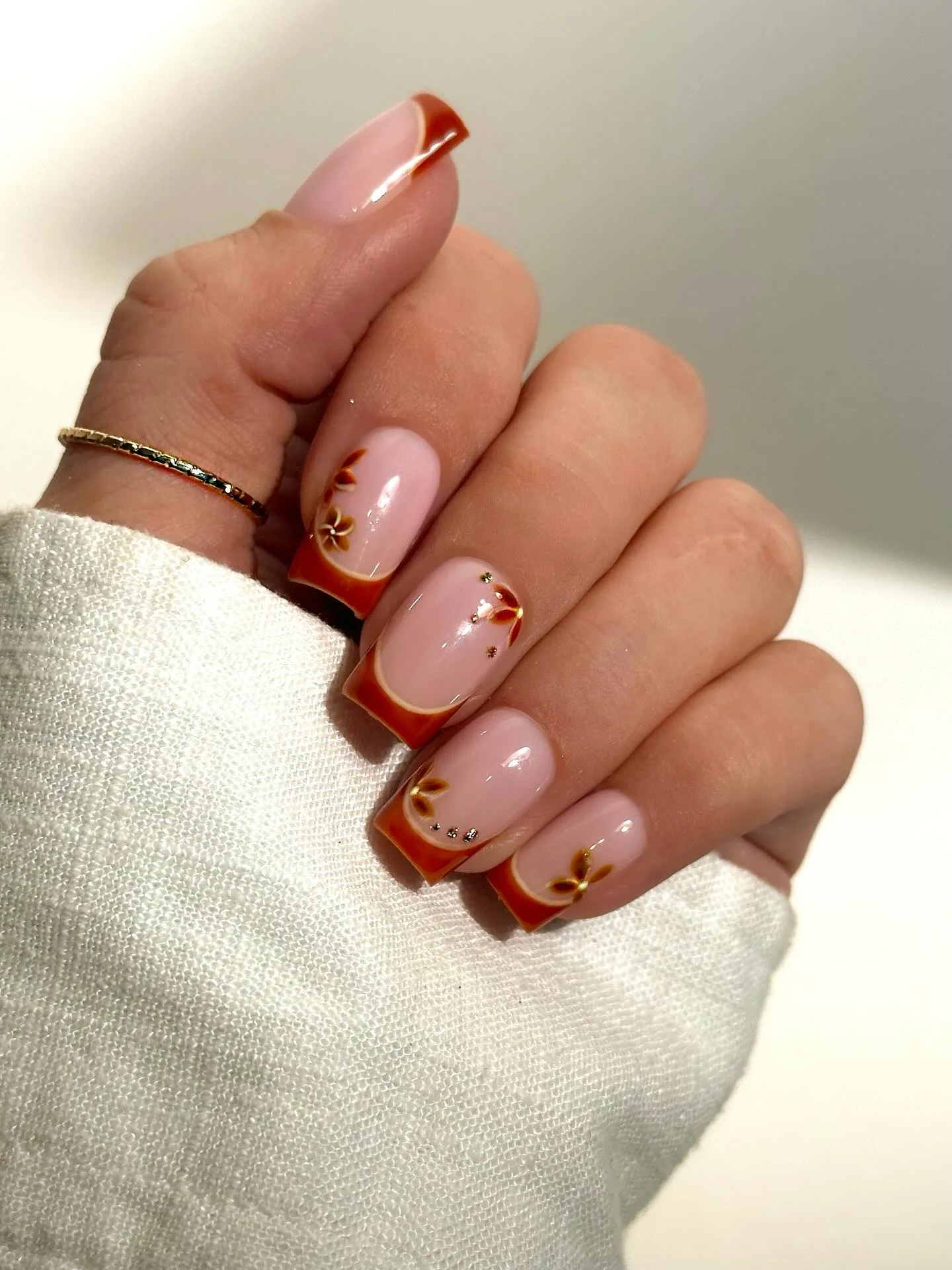 fall mid length nails 2026 Warm Cinnamon French Tips With Minimal Floral Details