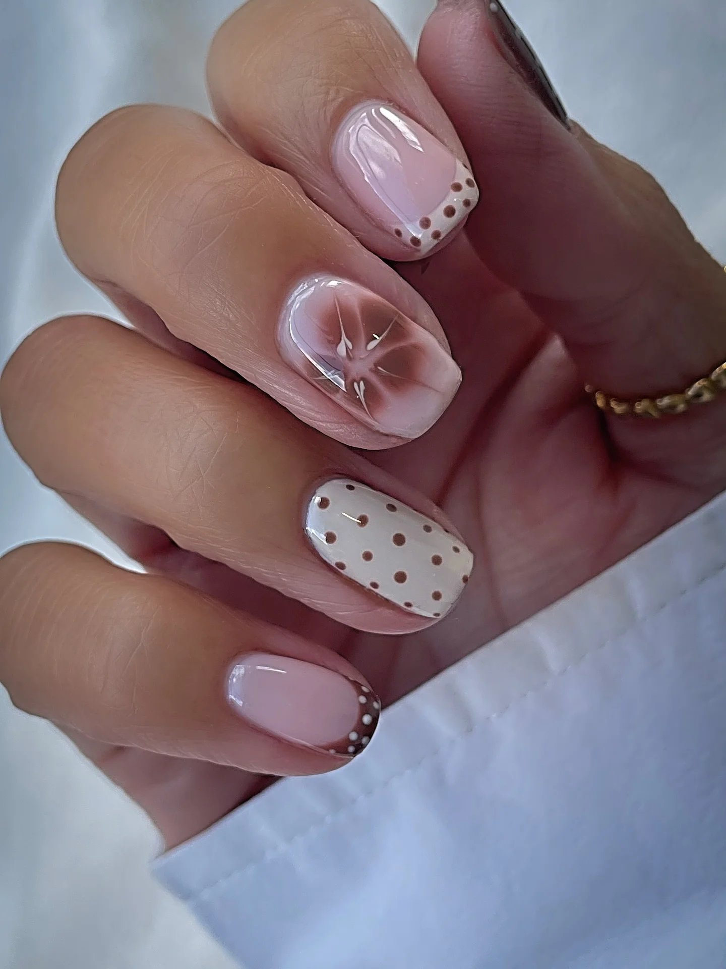 polka dot fall nails 2026 Blush French Tips With Tiny Brown Dots And Floral Art