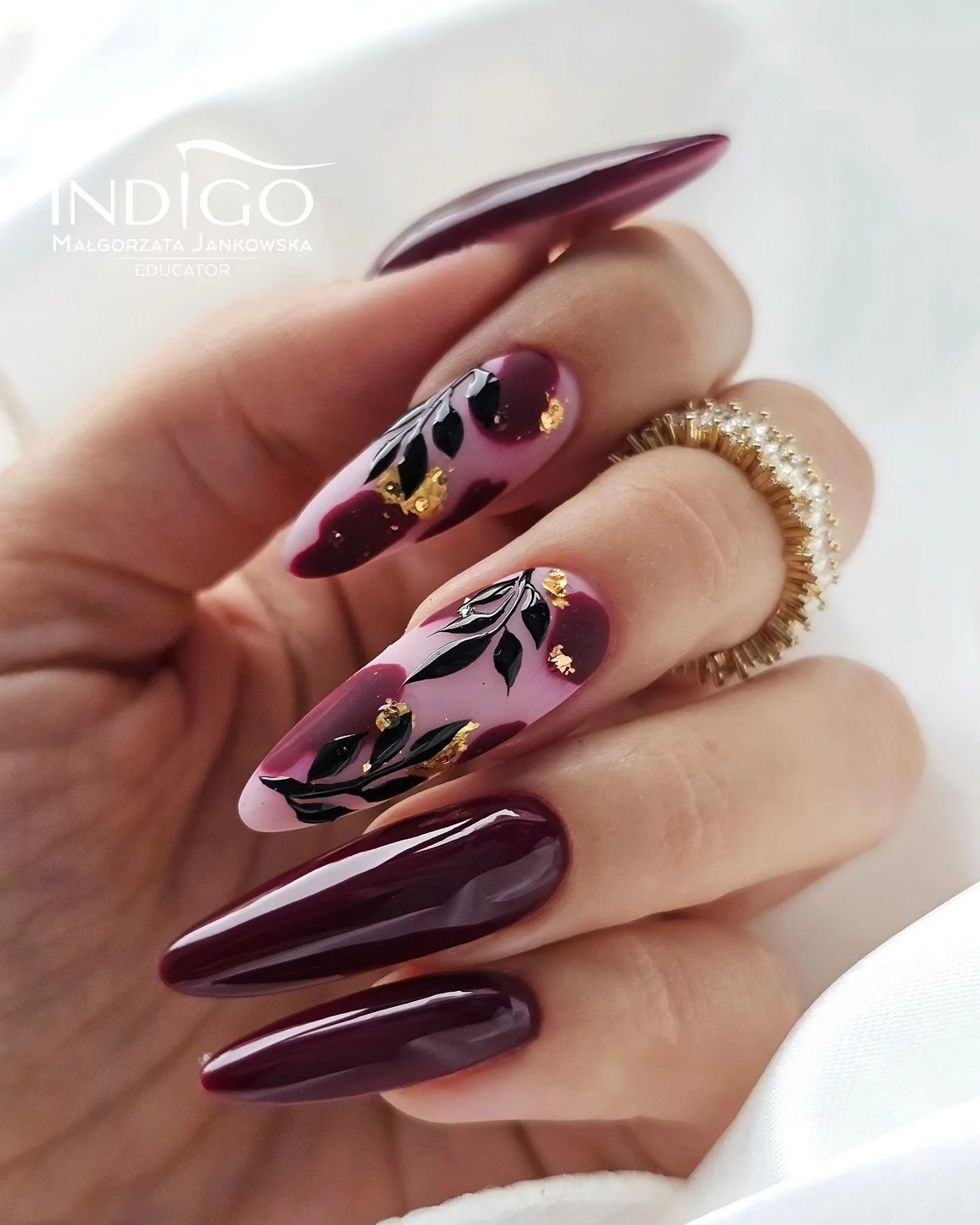 fall dark nail shadow ideas 2026 Deep Burgundy Almond Nails With Botanical Gold Details