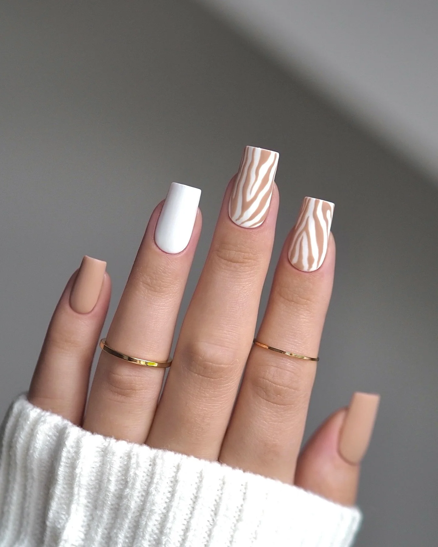 fall matte nails 2026 Soft Nude And Cream With Zebra-Inspired Waves
