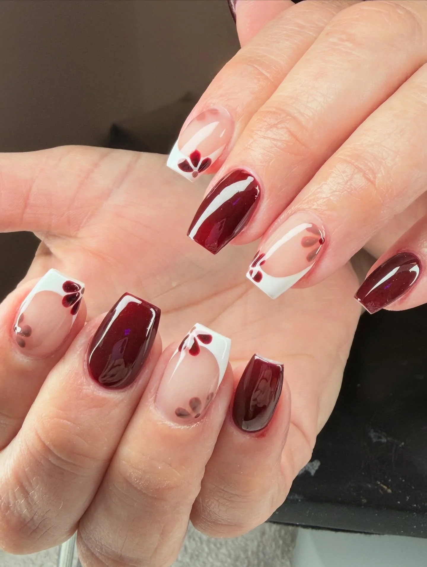 fall short coffin nails designs 2026 Burgundy French Tips With Tiny Floral Accents