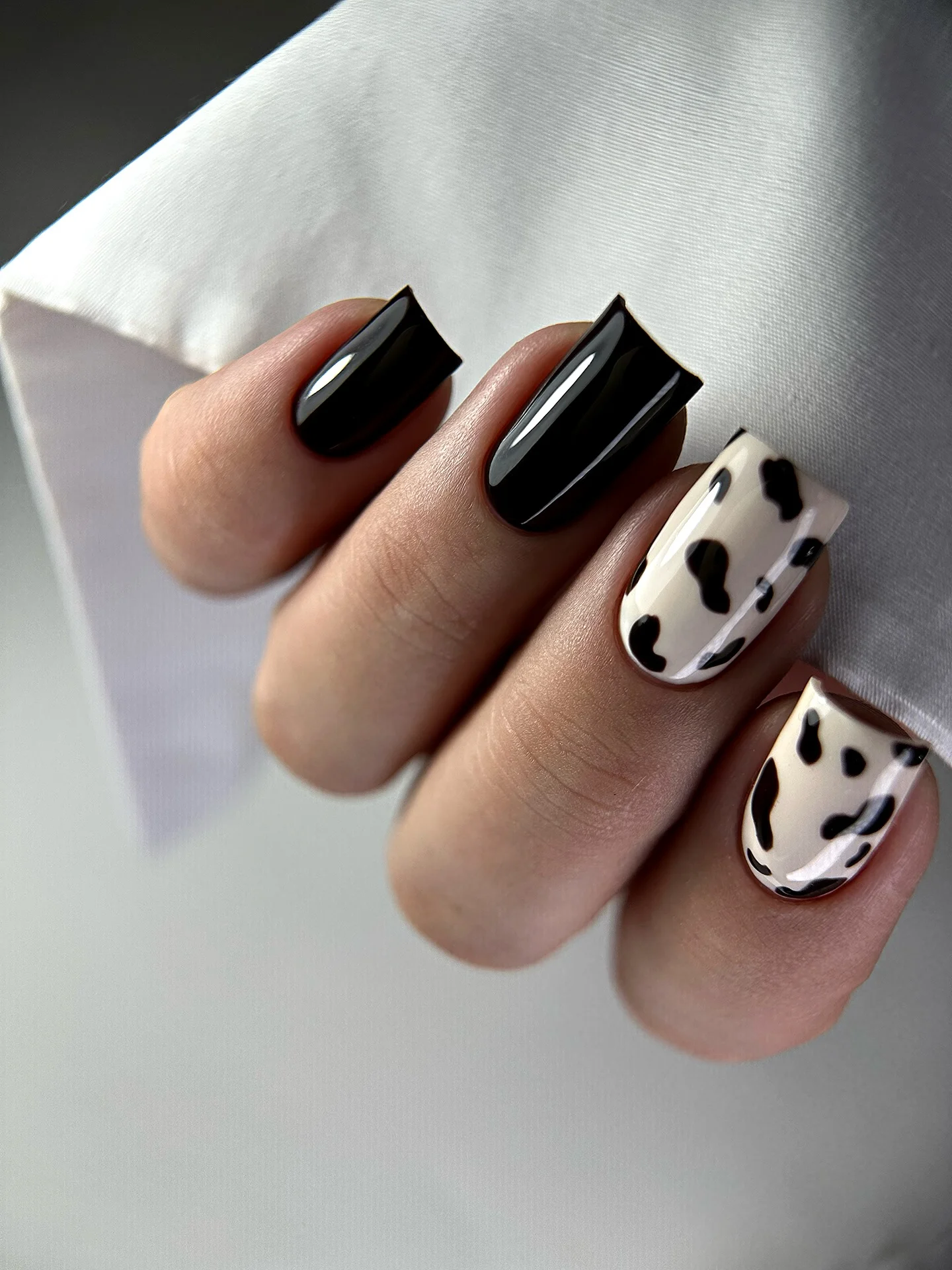 fall dark nail shadow ideas 2026 Glossy Black And Cow Print Contrast