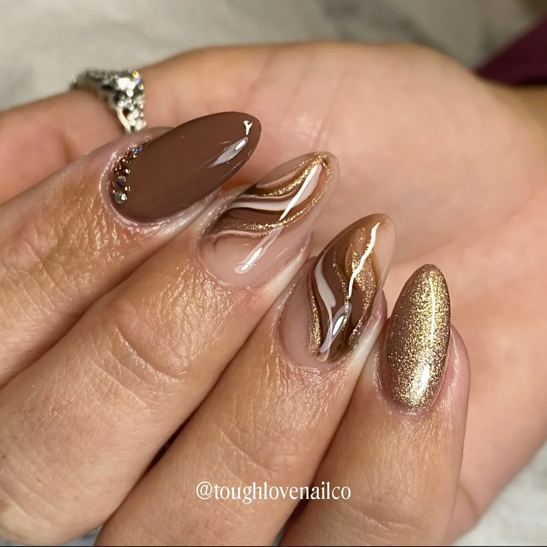 fall gel nails ideas 2026 Golden Bronze Swirl Nails With Metallic Shine